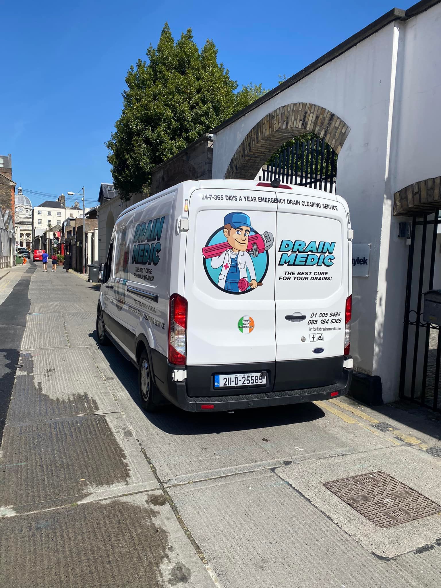 A white van is parked on the side of a street.
