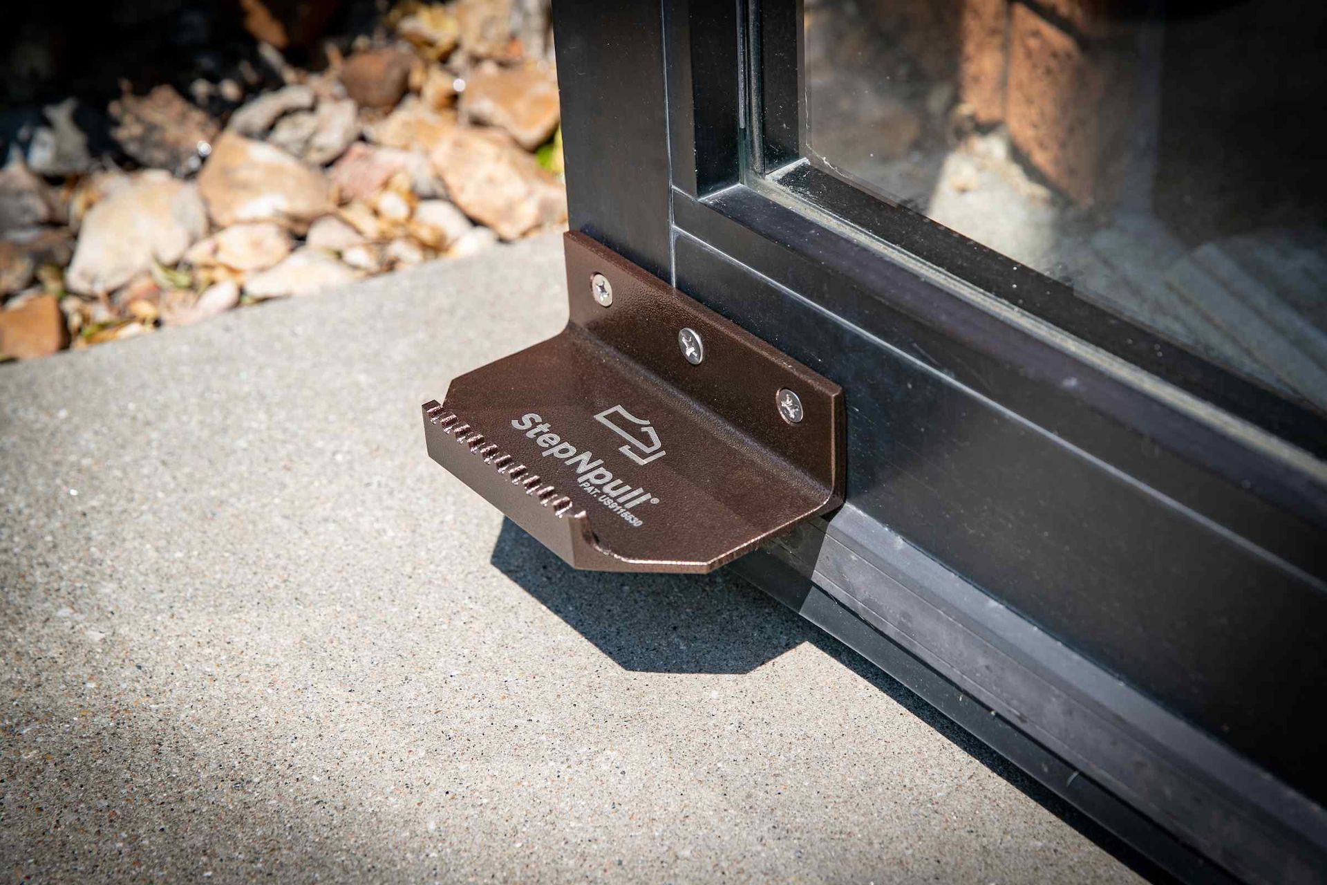 A close up of a door with a foot pedal attached to it.