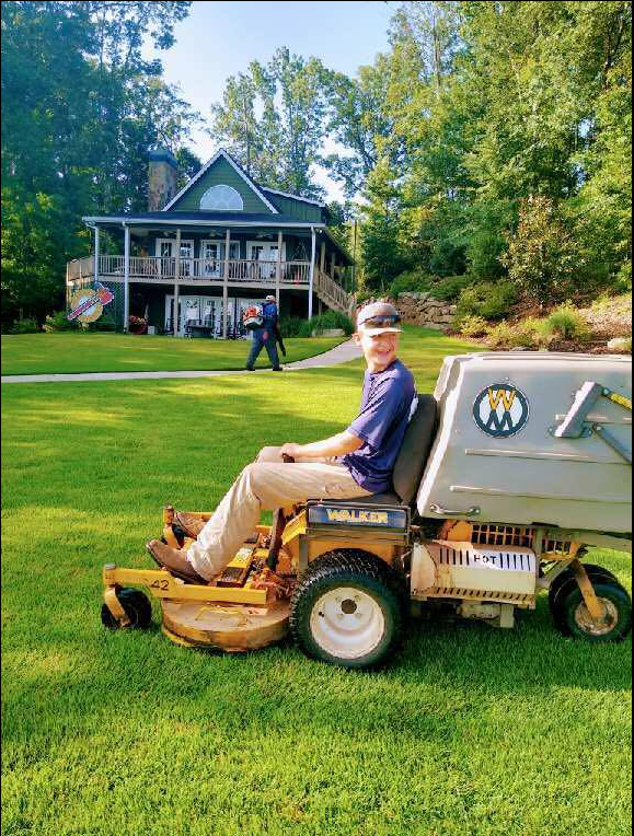Man Using Lawn Mower — Watkinsville, GA — Four Seasons Lawn Maintenance