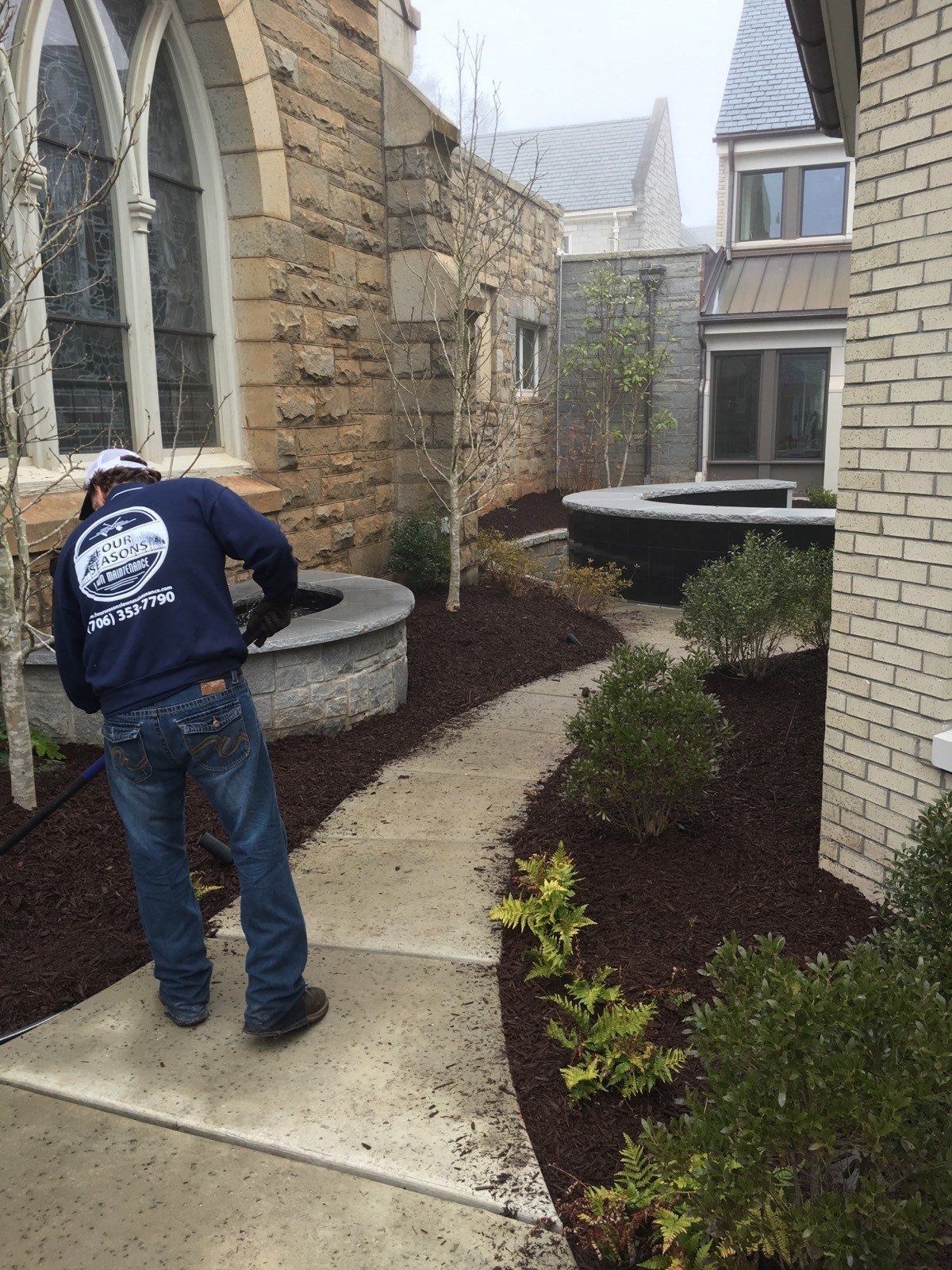 Man Adding Mulch — Watkinsville, GA — Four Seasons Lawn Maintenance
