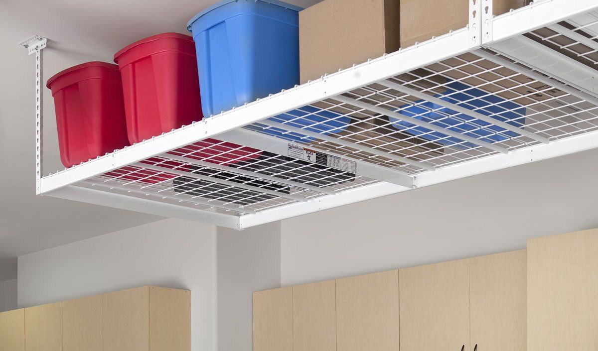 A ceiling rack with boxes and bins on it in a garage.