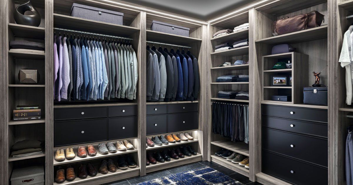 a walk in closet filled with lots of clothes and shoes .
