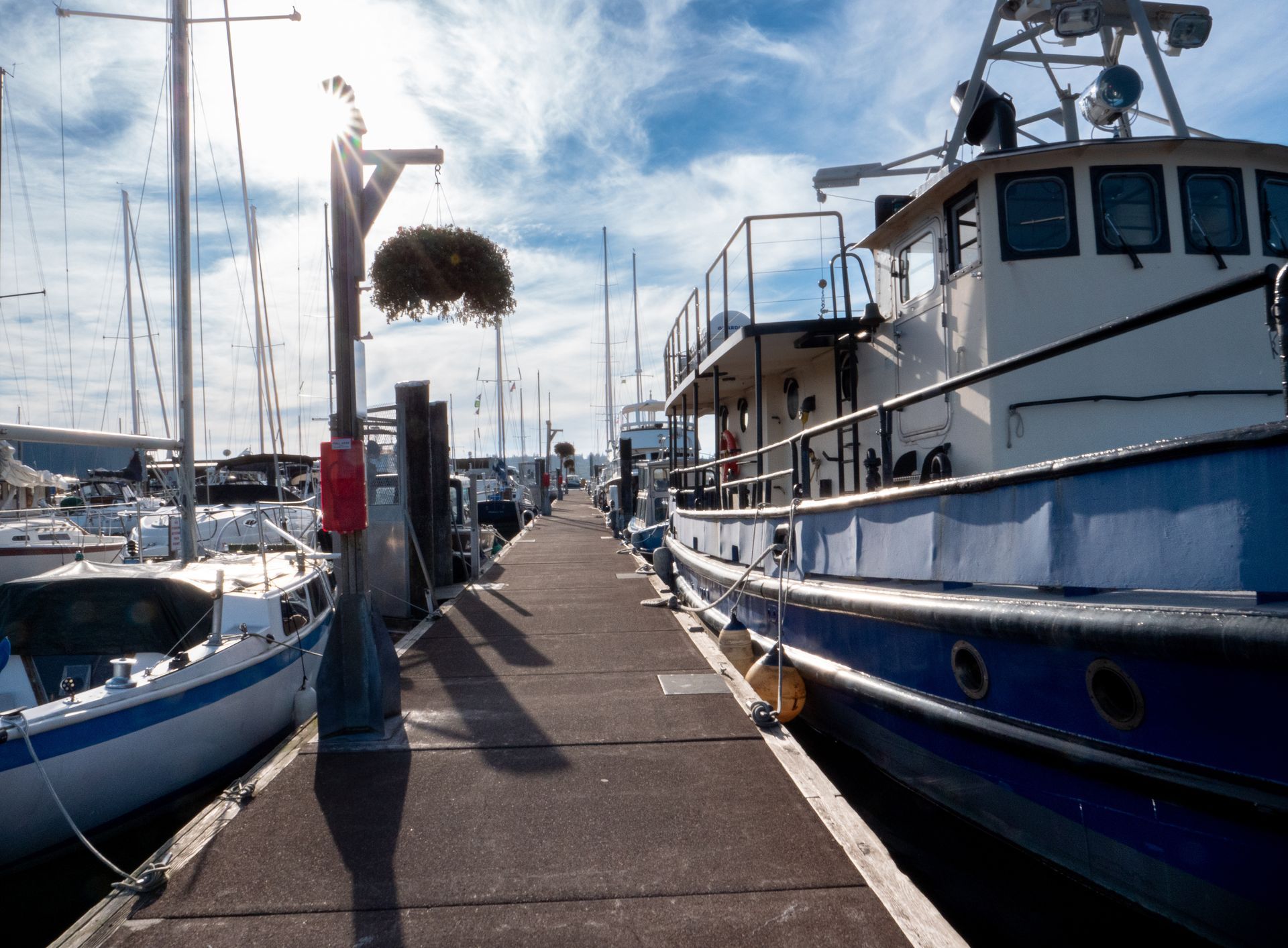 Boats are docked at a marina on a sunny day