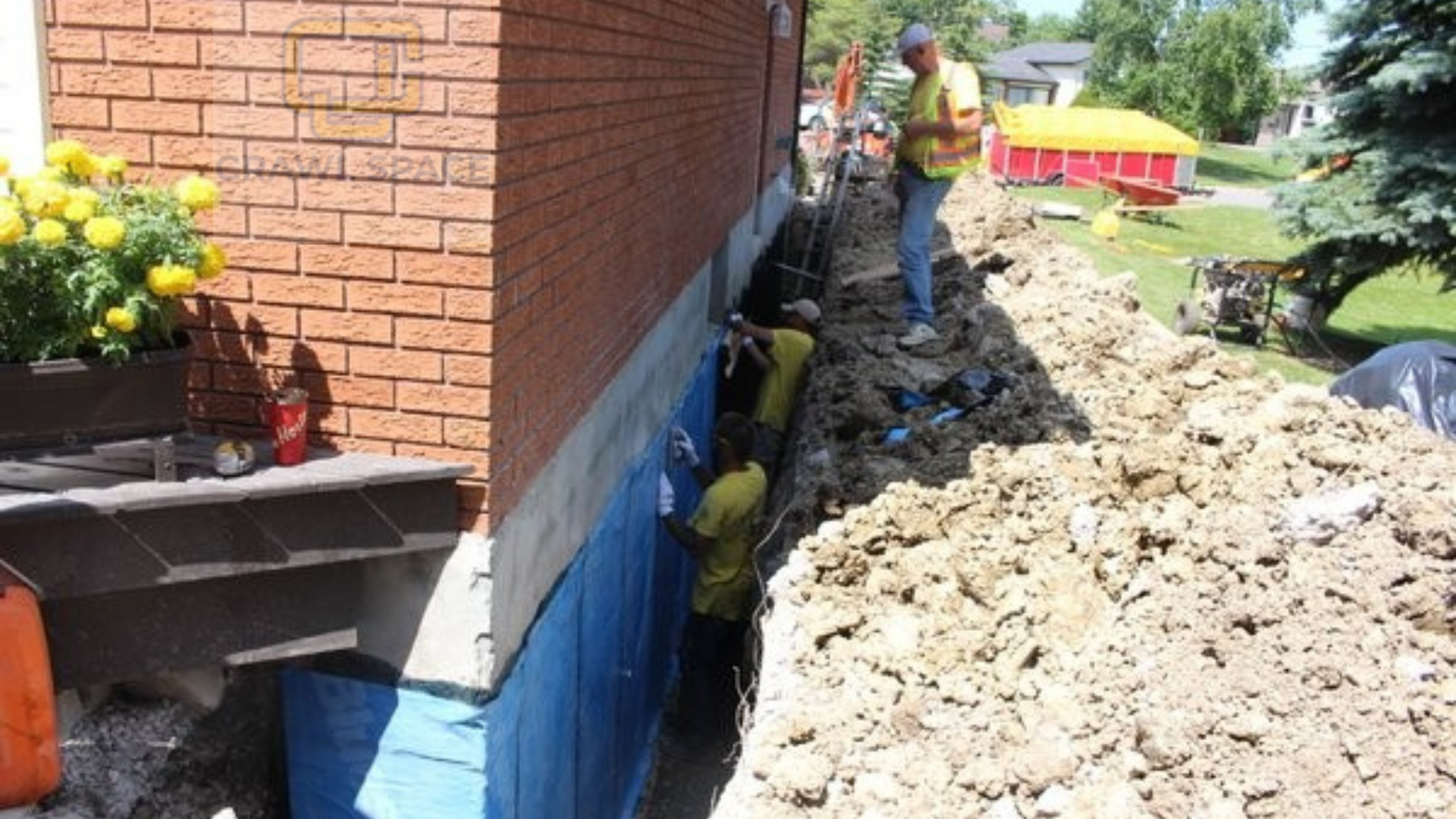 A group of construction workers are working on the side of a brick building.