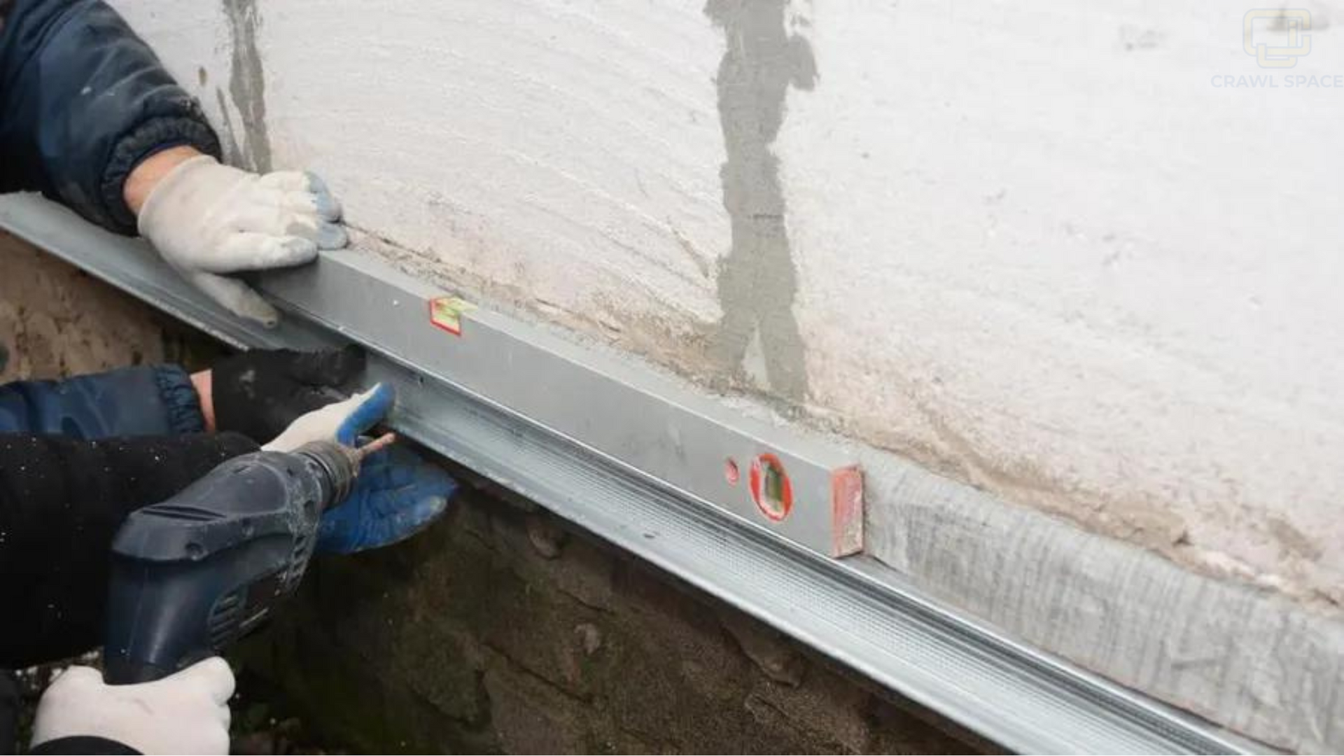 A man is using a level to measure a wall.