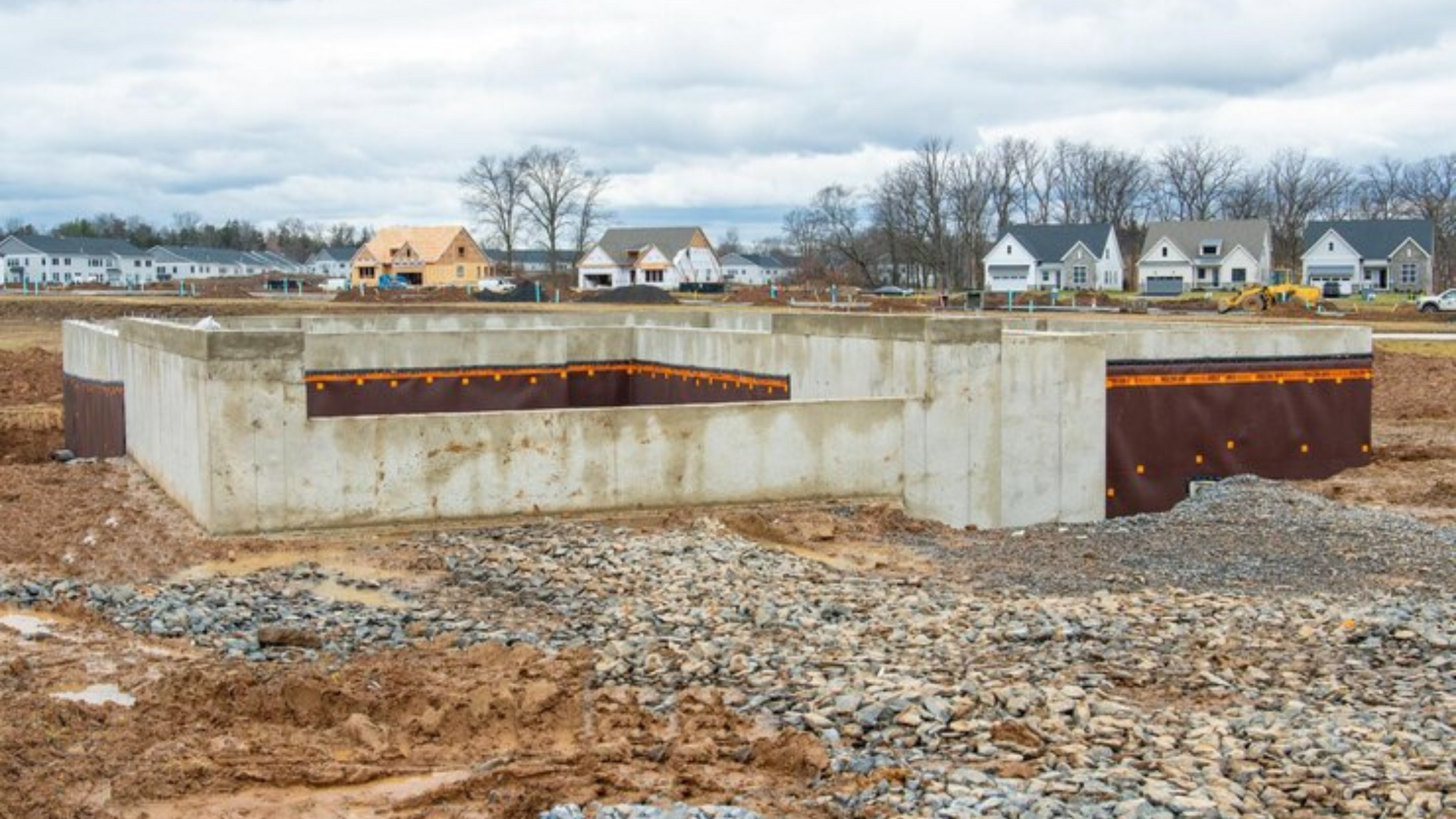 A concrete foundation is being built in a construction site.