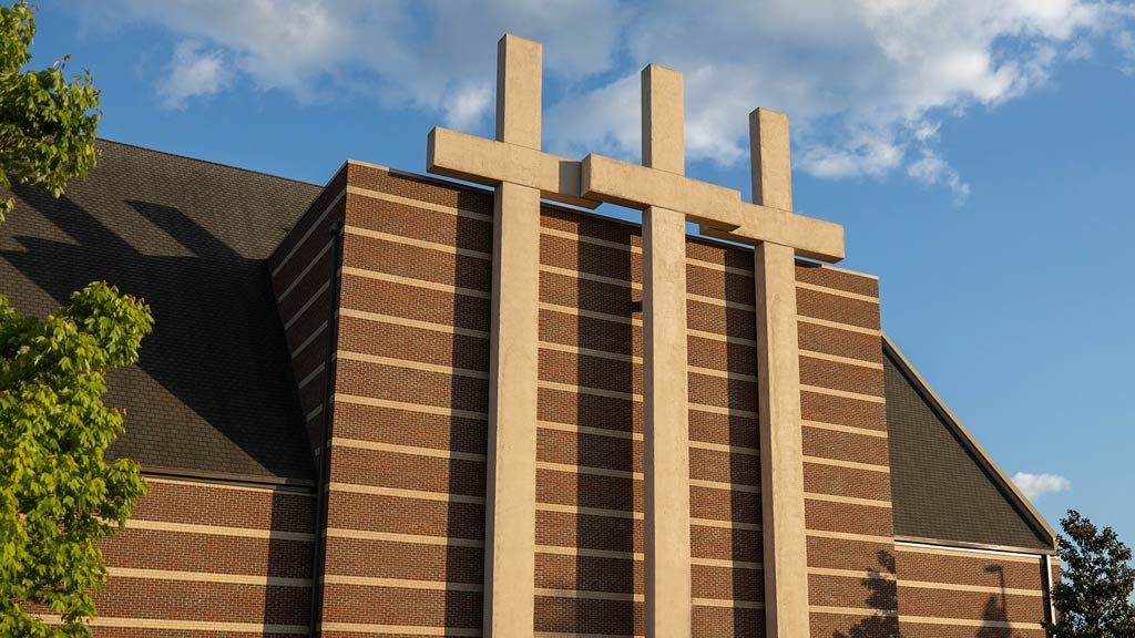 A church with three crosses on the side of it