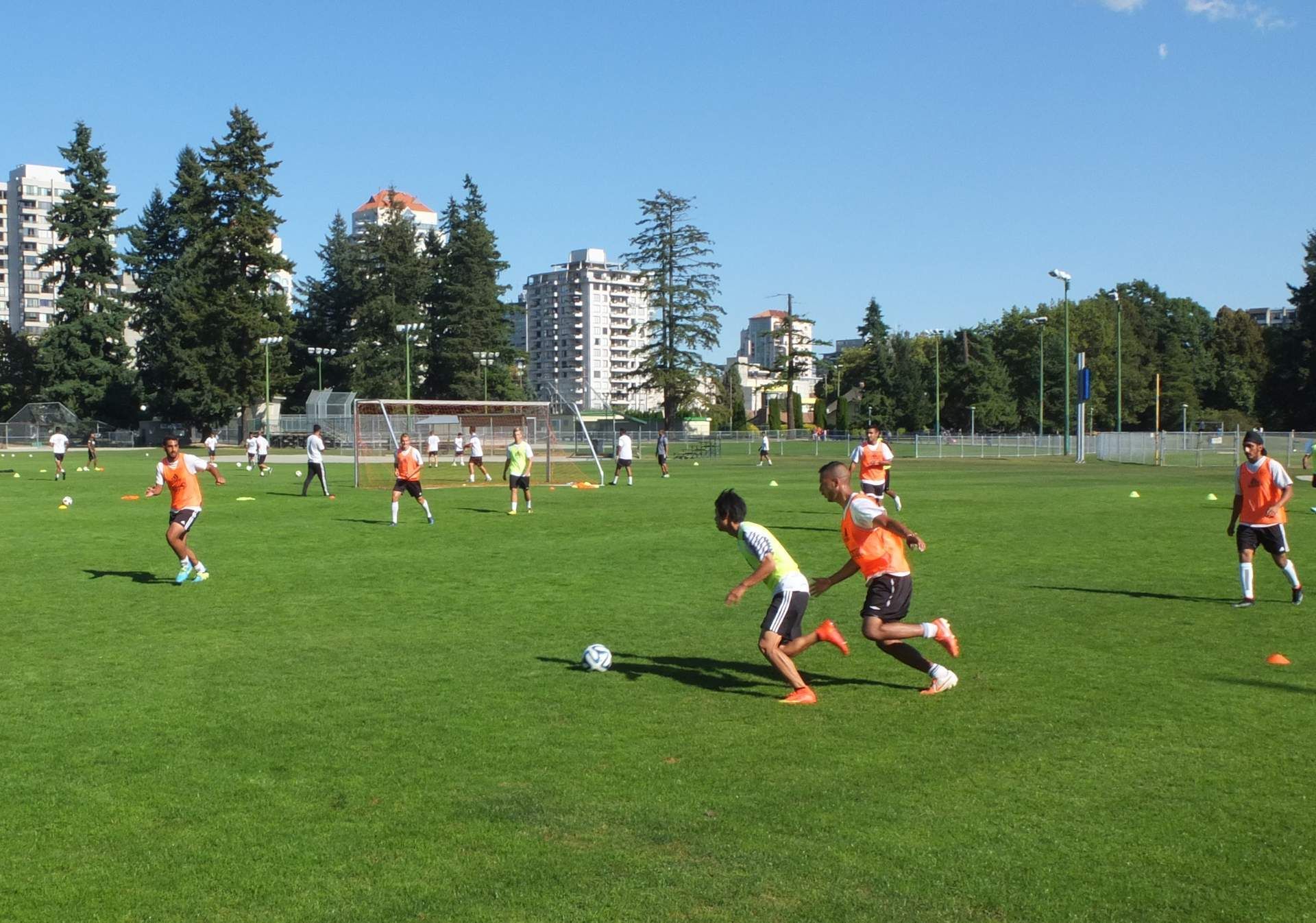 A group of people are playing soccer on a field