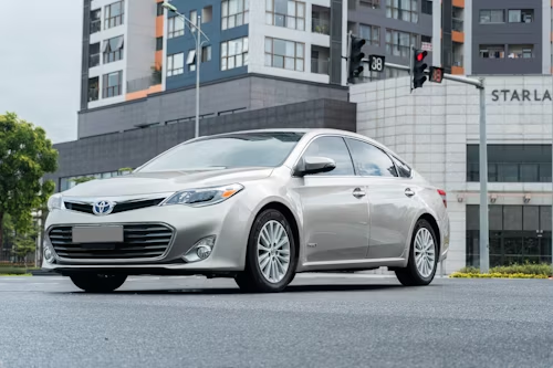 Silver sedan parked in front of a modern apartment building