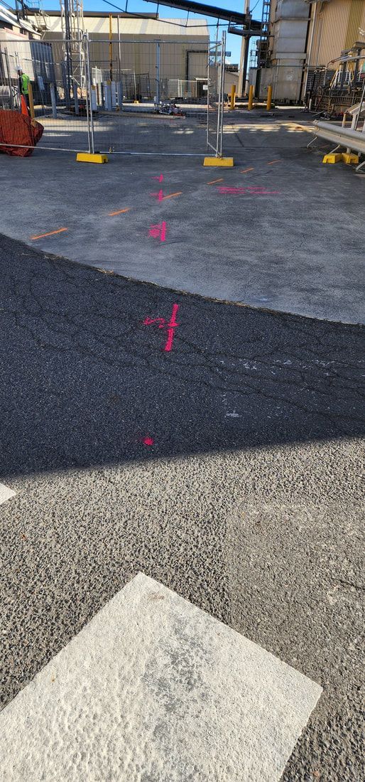 View of Industrial Site With Pink Markings on the Asphalt and Gravel — Found It Down Under in Gympie, QLD