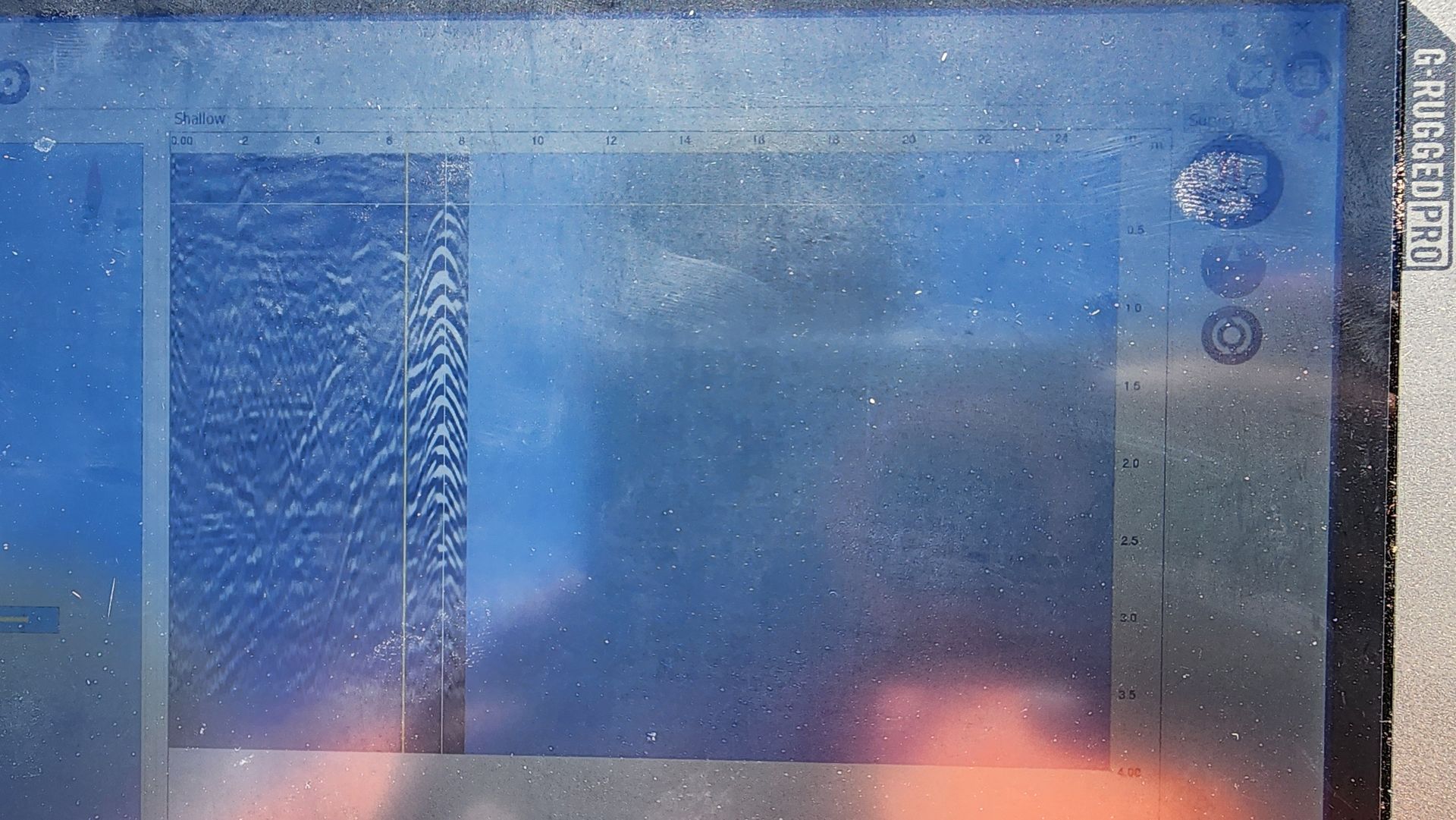 Blue-tinted, obscured screen showing static and possibly data or icons in black rectangular boxes with some white markings.