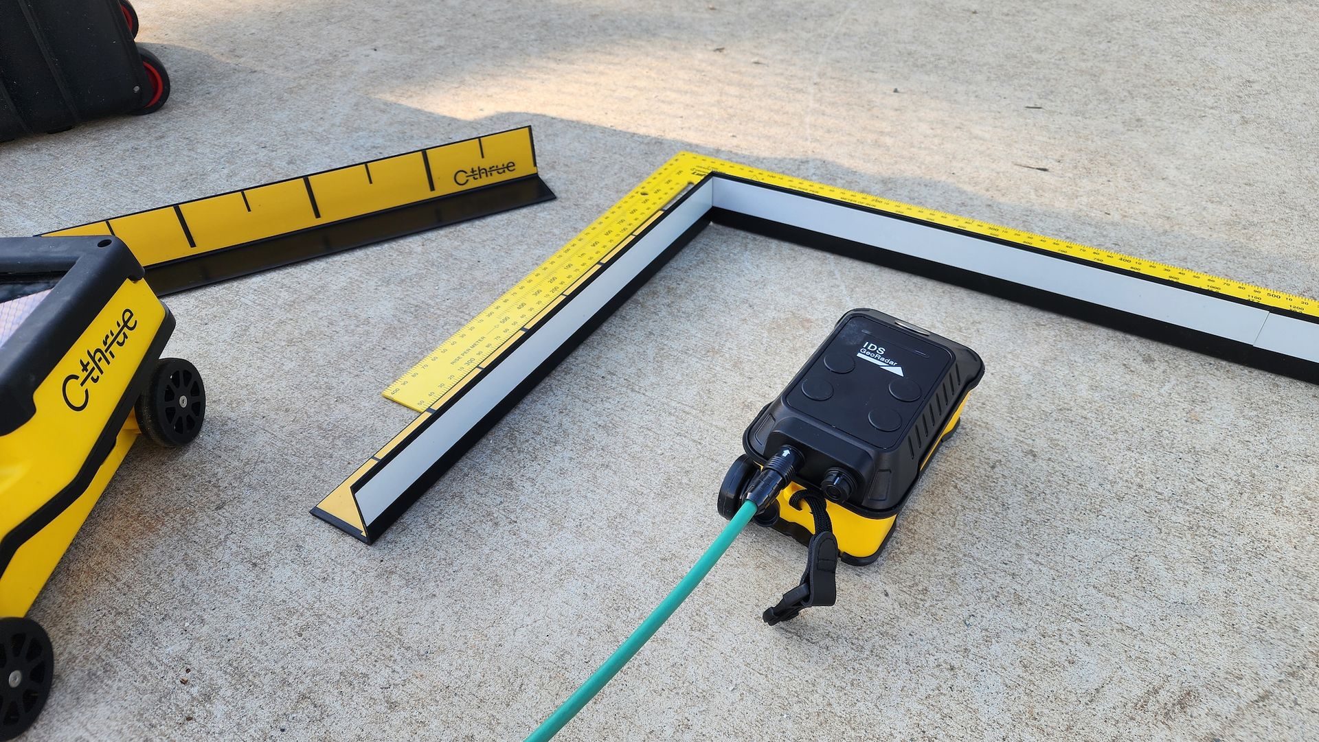 Yellow and Black Equipment With Measuring Guides and a Hose on Pavement — Found It Down Under in Gympie, QLD