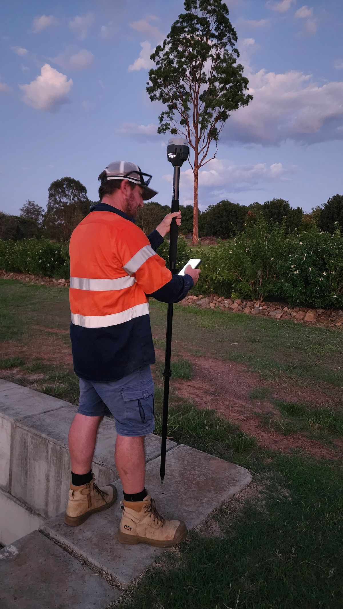 Man in work clothes uses surveying equipment outdoors. — Found It Down Under in Gympie, QLD