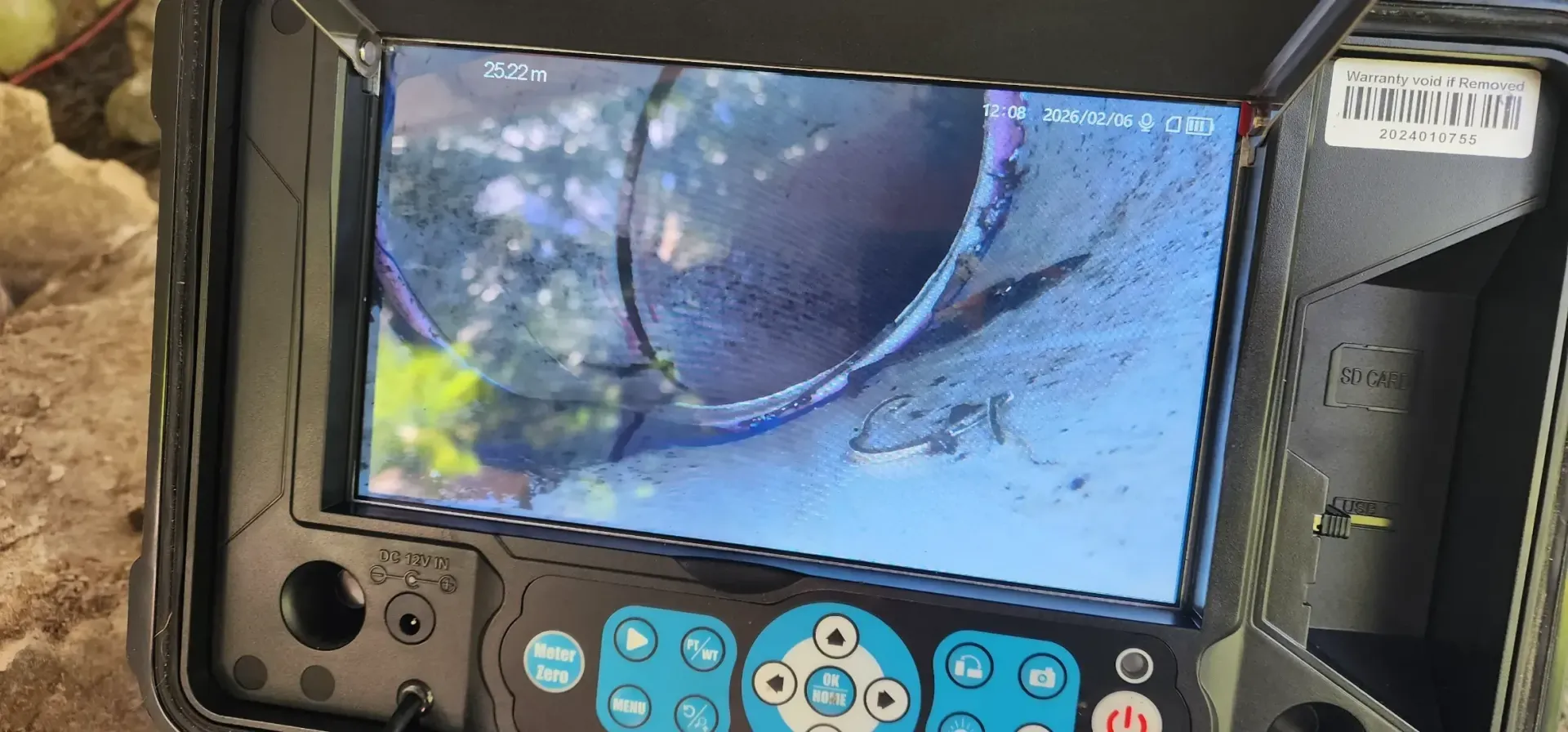 Close-up of a drain inspection camera displaying the inside of a pipe with some debris. — Found It Down Under in Gympie, QLD
