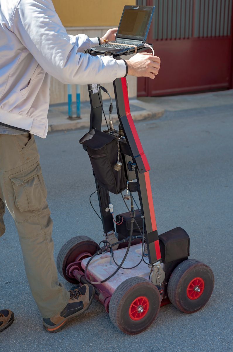 Person Using a Ground-penetrating Radar Cart Outdoors — Found It Down Under in Hervey Bay, QLD