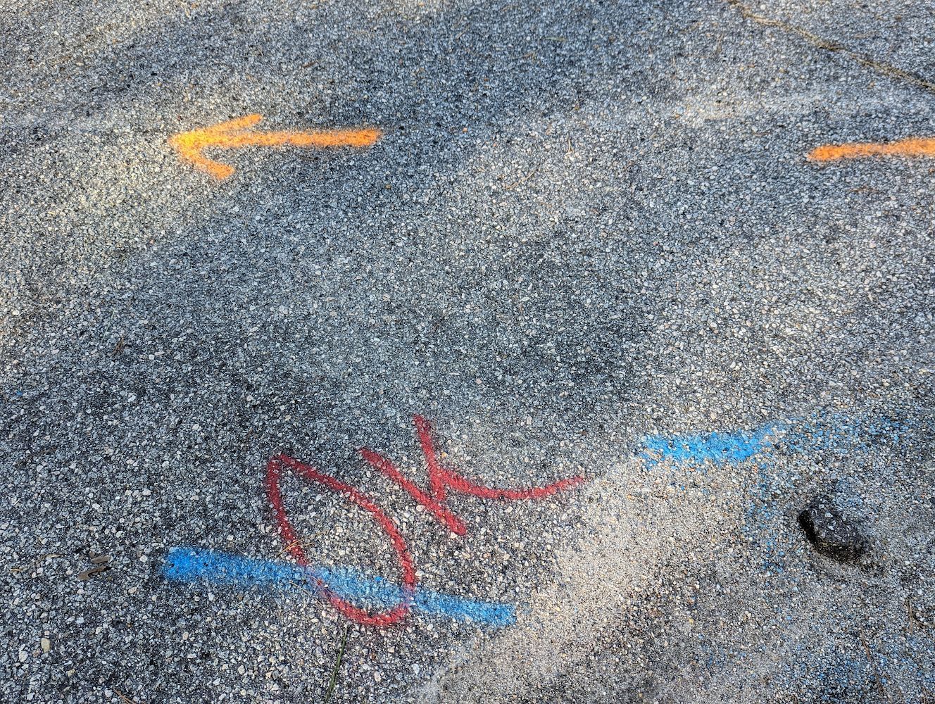 Arrows Painted on a Gray, Pebbled Surface — Found It Down Under in Hervey Bay, QLD
