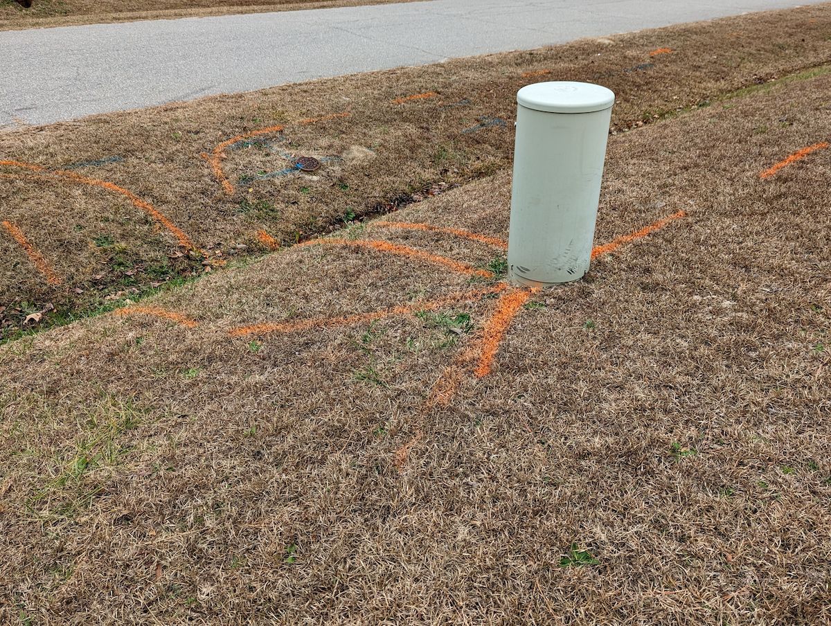 White Utility Pole in Brown Grass With Orange Markings, Near a Road — Found It Down Under in Tin Can Bay, QLD