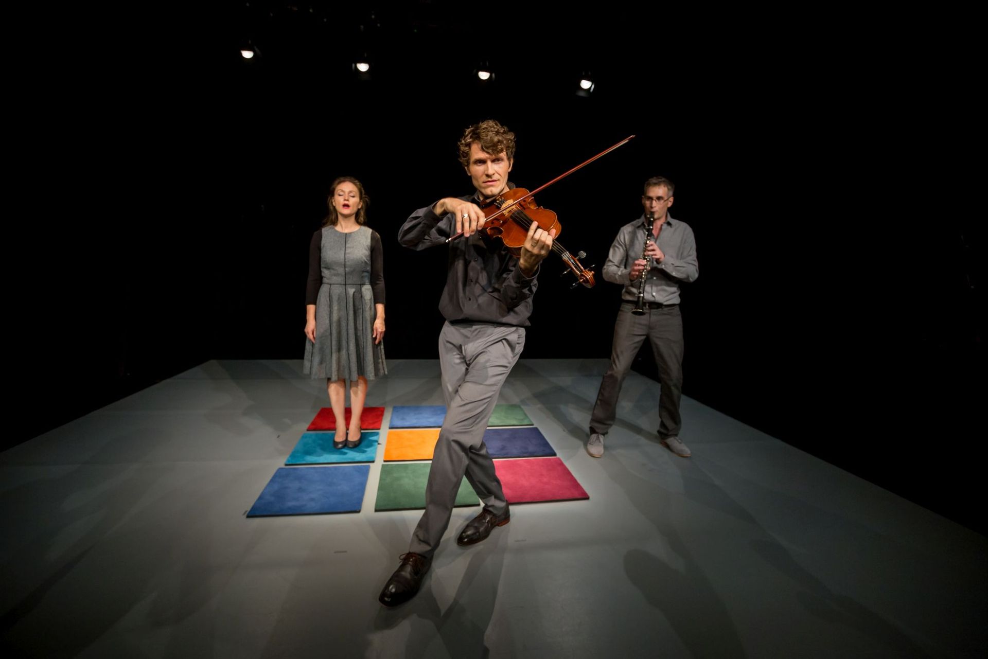 Eine Frau steht vor einem Stapel bunter Handtücher