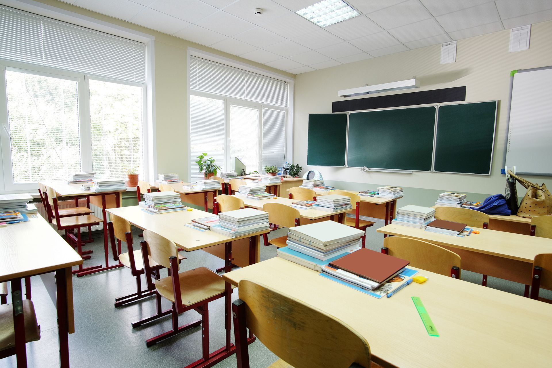 Empty classroom with desks, chalkboard, and windows. Empty classroom with desks, chalkboard, and windows.