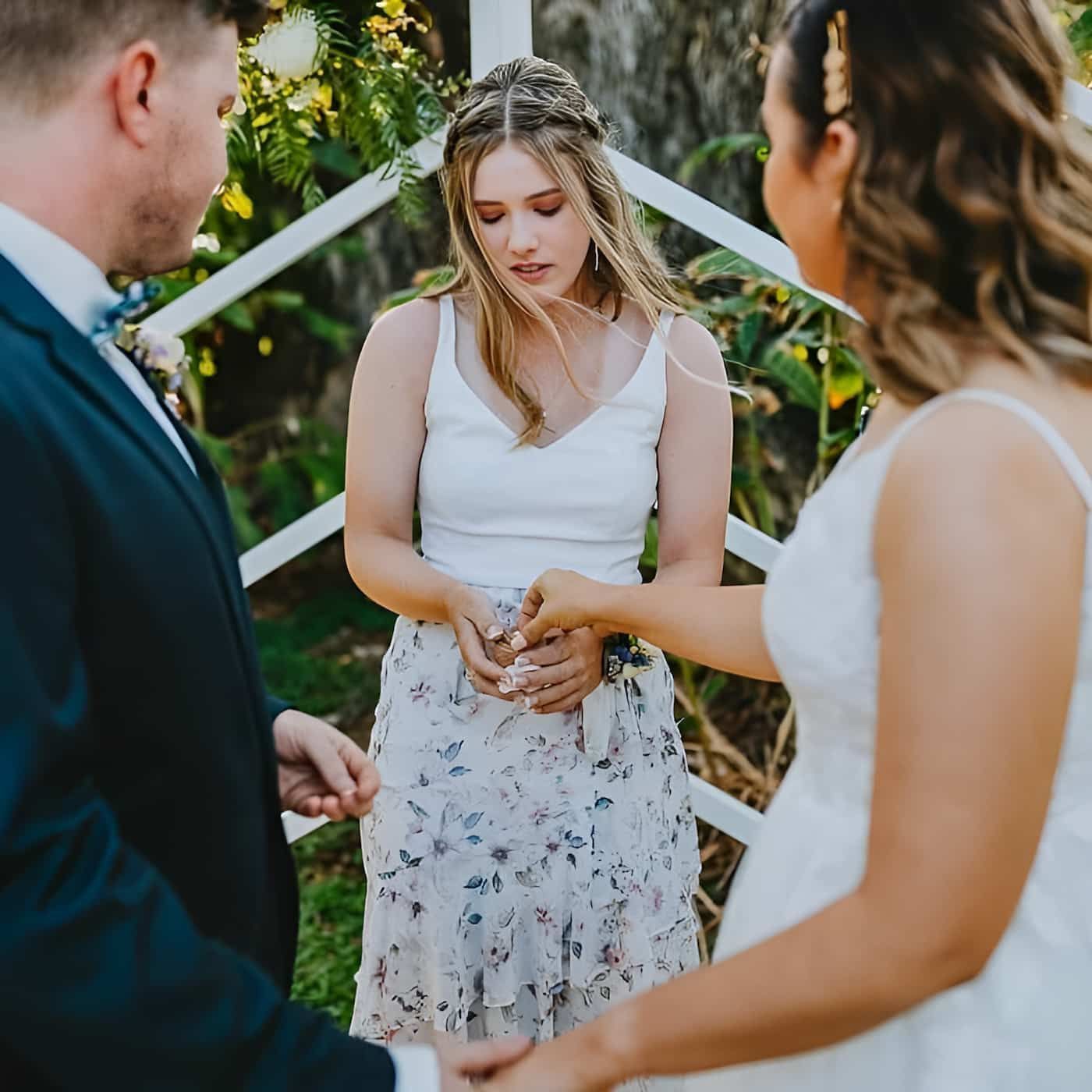 A Bride And Groom Are Standing Next To Each Other Holding Hands — Lynda Ross Marriage Celebrant In Richmond, QLD