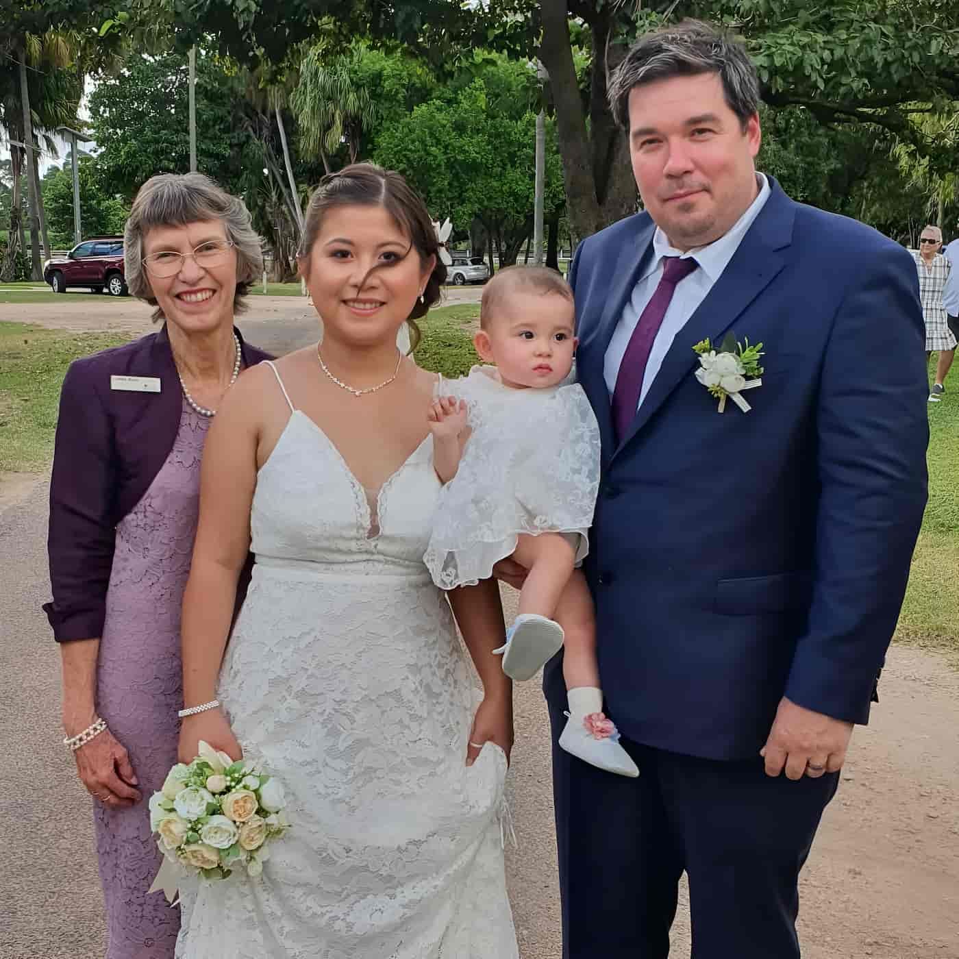 A Bride And Groom Pose For A Picture With Their Baby — Lynda Ross Marriage Celebrant In Ayr, QLD
