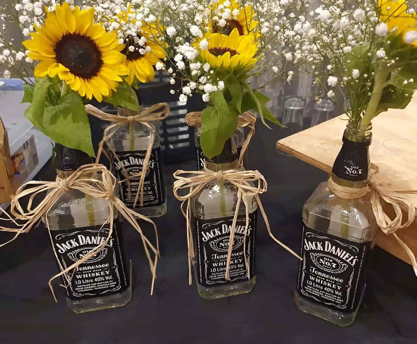 Four Bottles Of Jack Daniels With Sunflowers In Them — Lynda Ross Marriage Celebrant In Ayr, QLD
