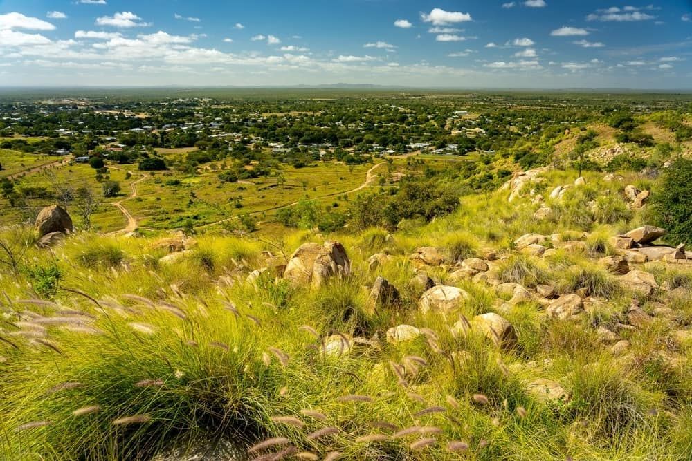 A Lush Green Landscape With A Small Town In The Distance — Lynda Ross Marriage Celebrant In Charters Towers, QLD