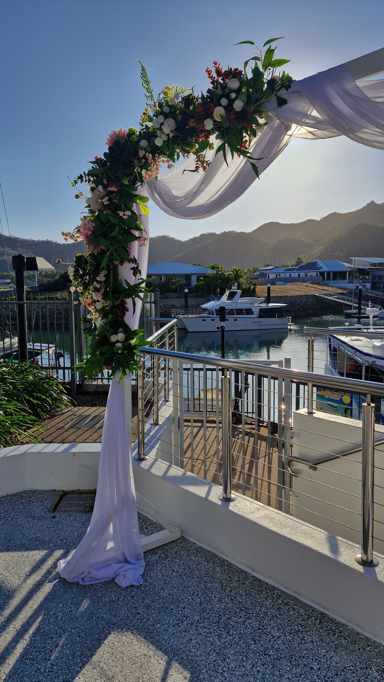 A Wedding Arch Decorated With Flowers For A Wedding Ceremony — Lynda Ross Marriage Celebrant In Alice River, QLD
