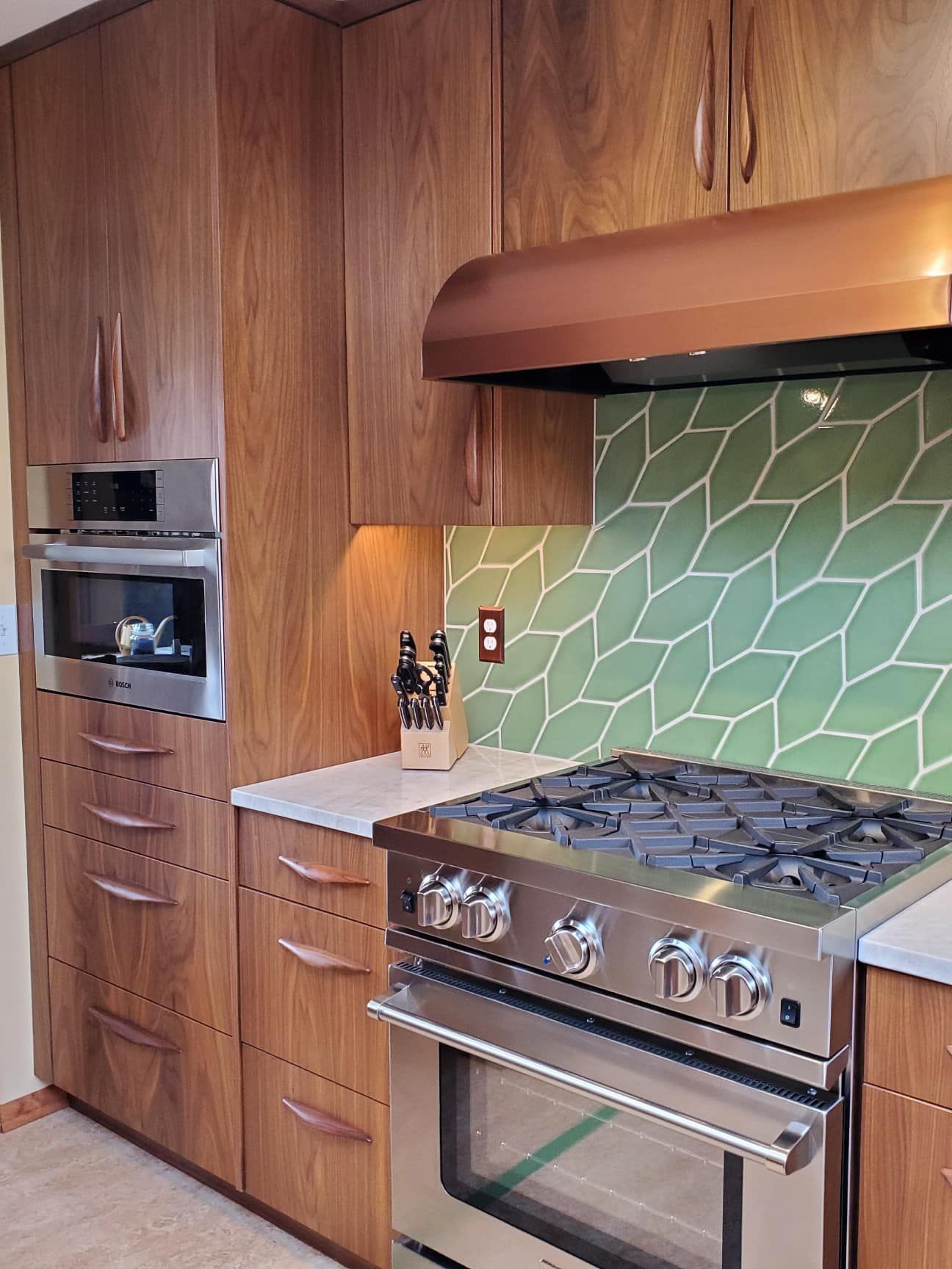 A kitchen with stainless steel appliances and wooden cabinets