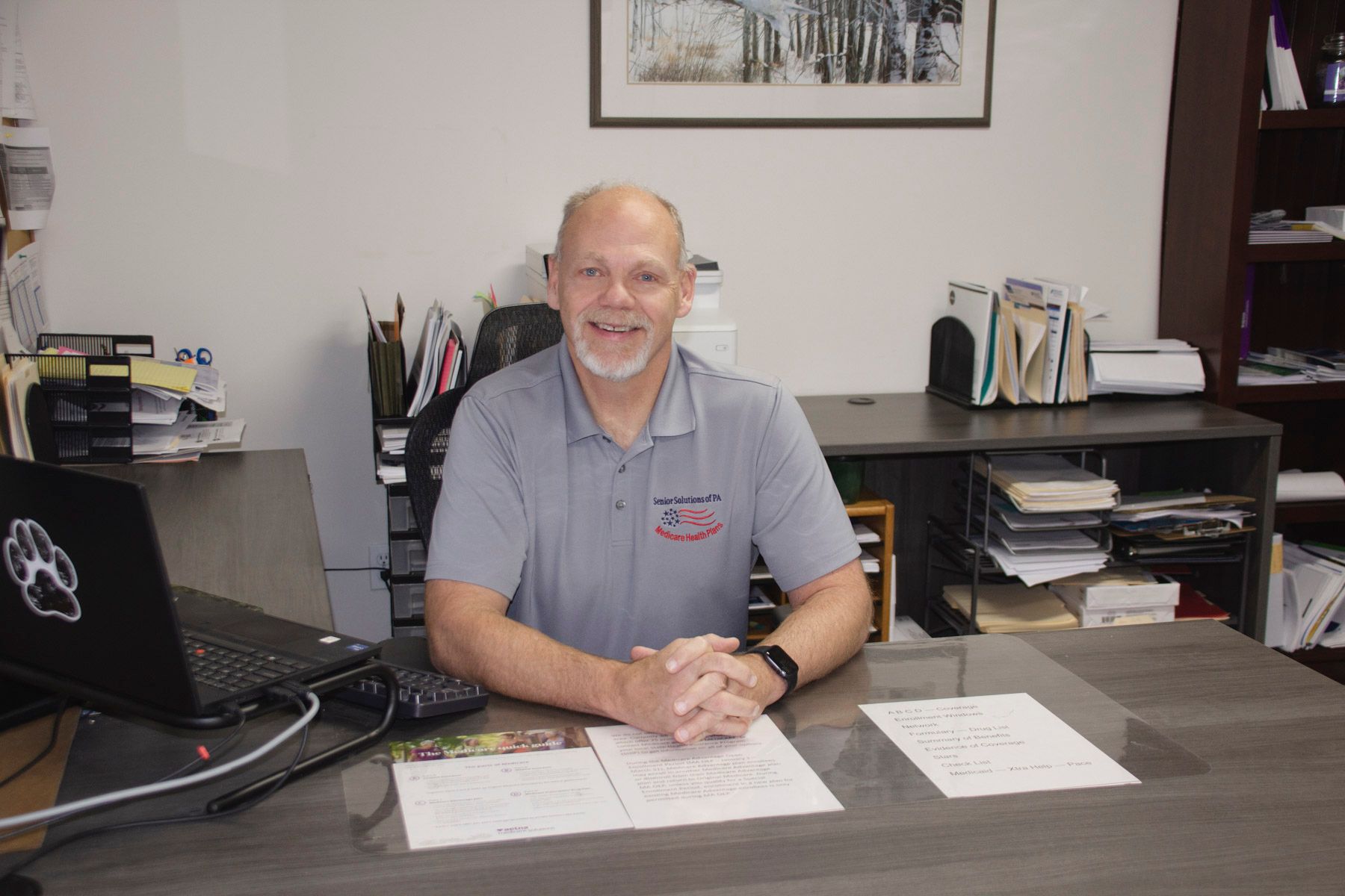 A close up of a wheat field with a blue sky in the background.