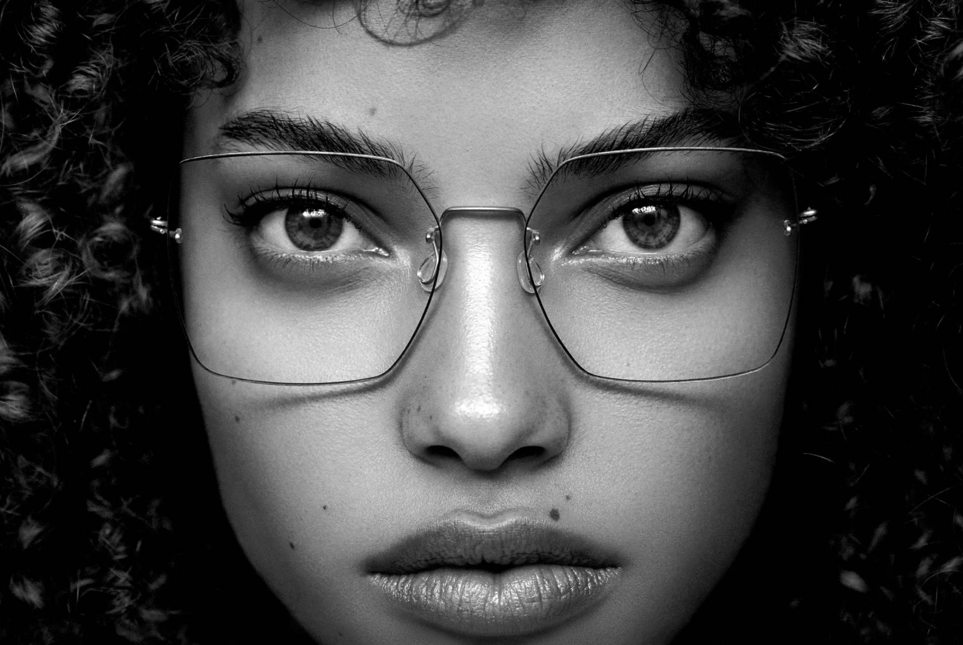 Une photo en noir et blanc d'une femme portant des lunettes.