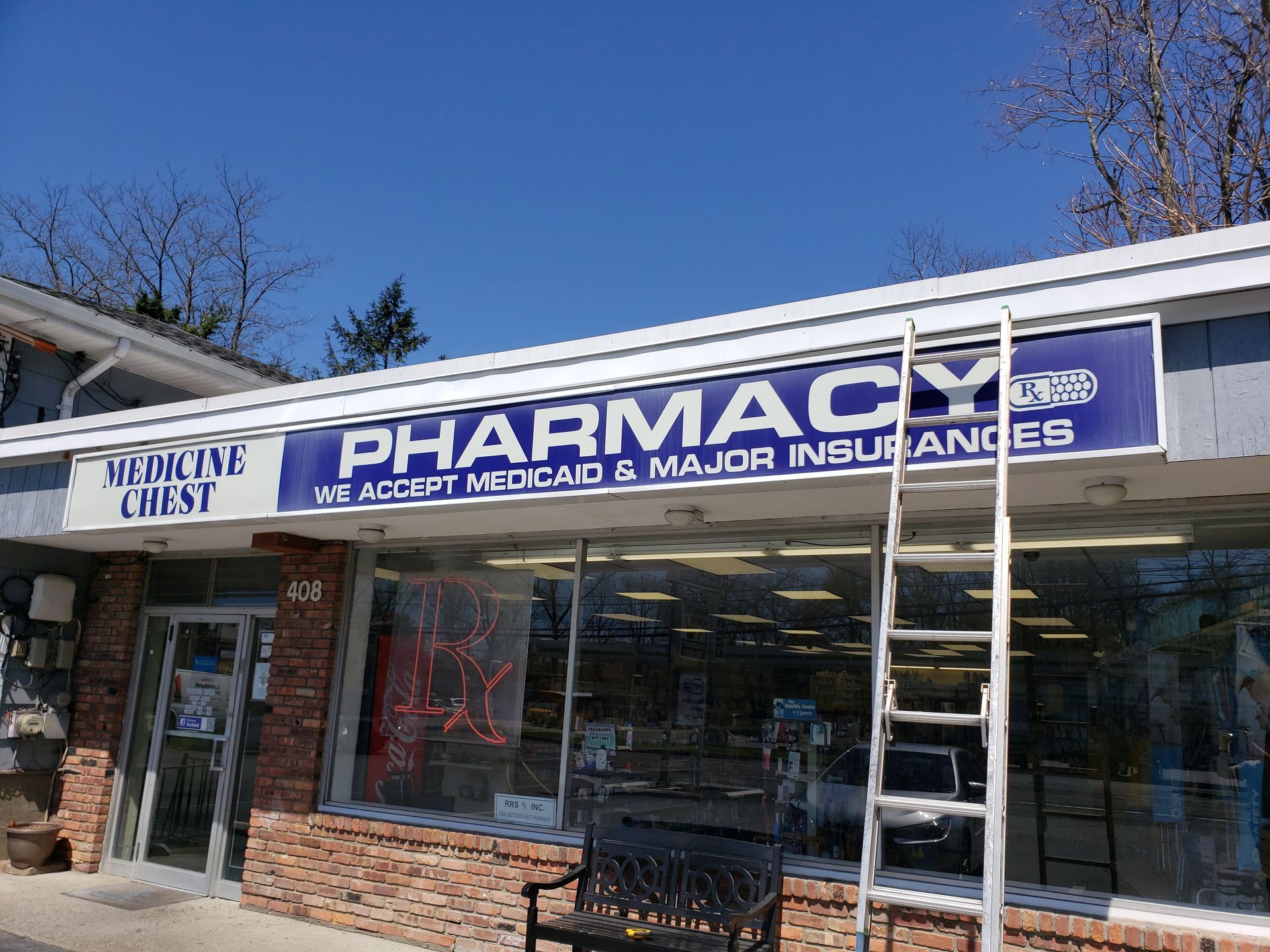 A pharmacy with a ladder on the side of it