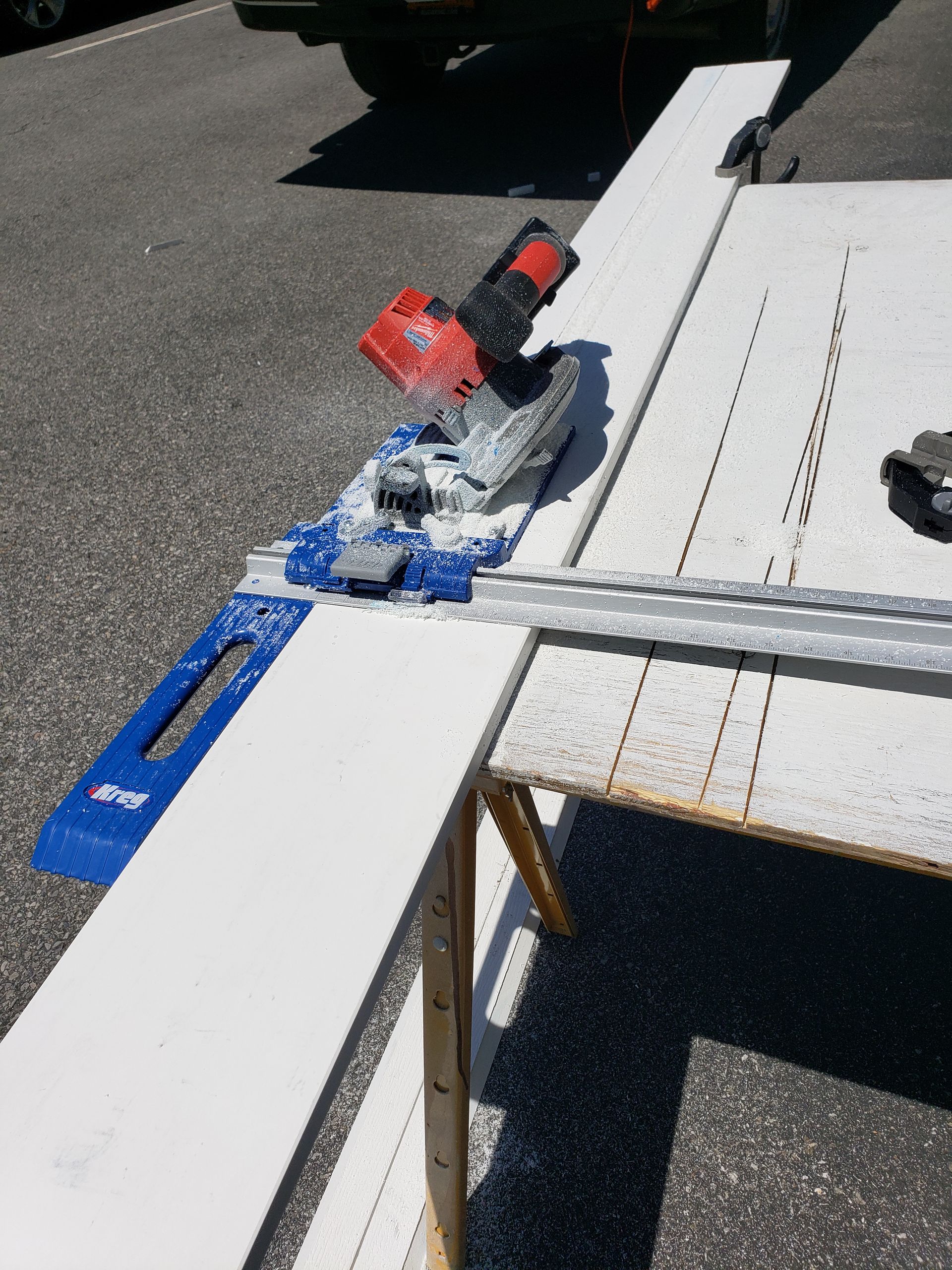 A circular saw is sitting on top of a white table.