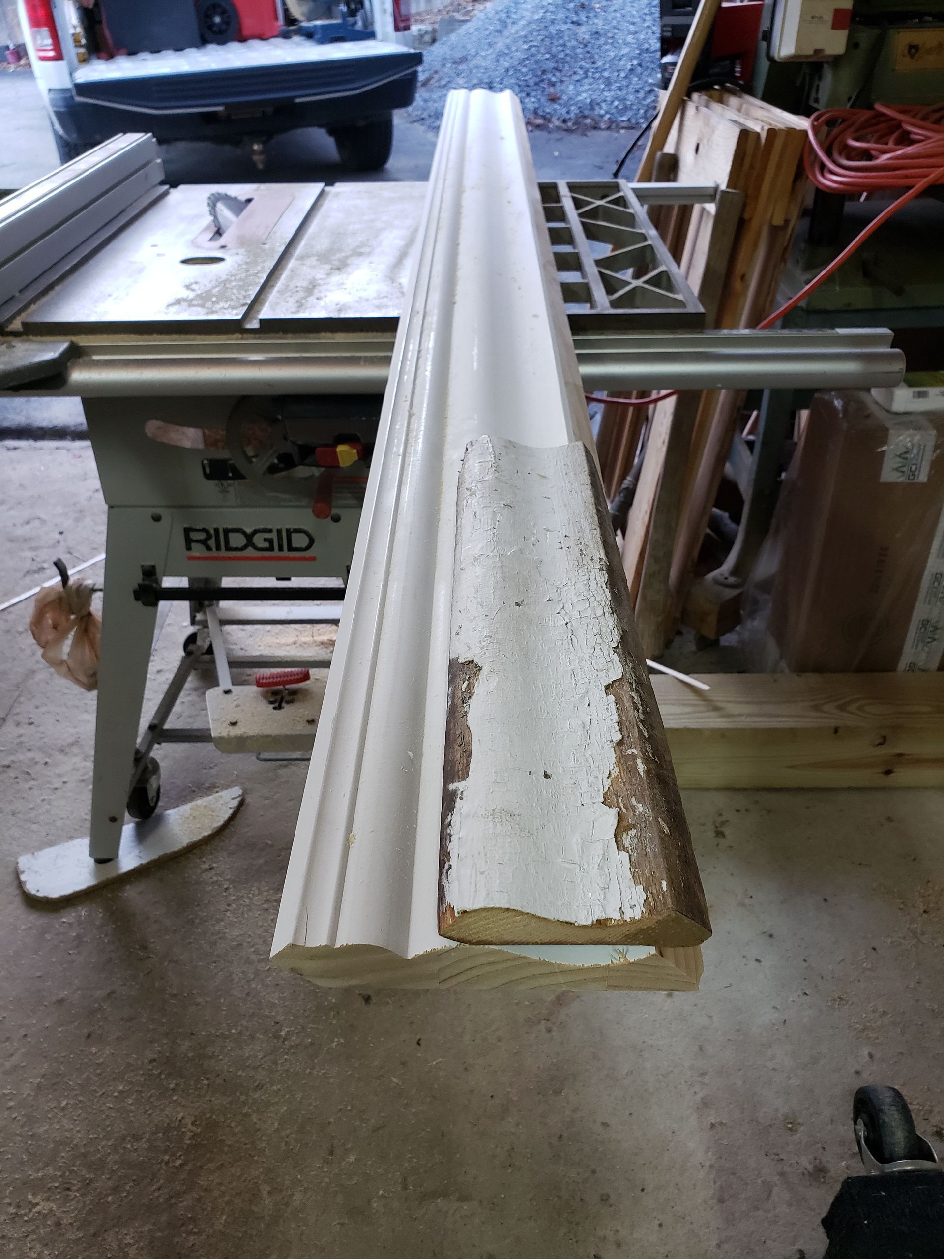 A piece of wood is sitting on top of a table saw.