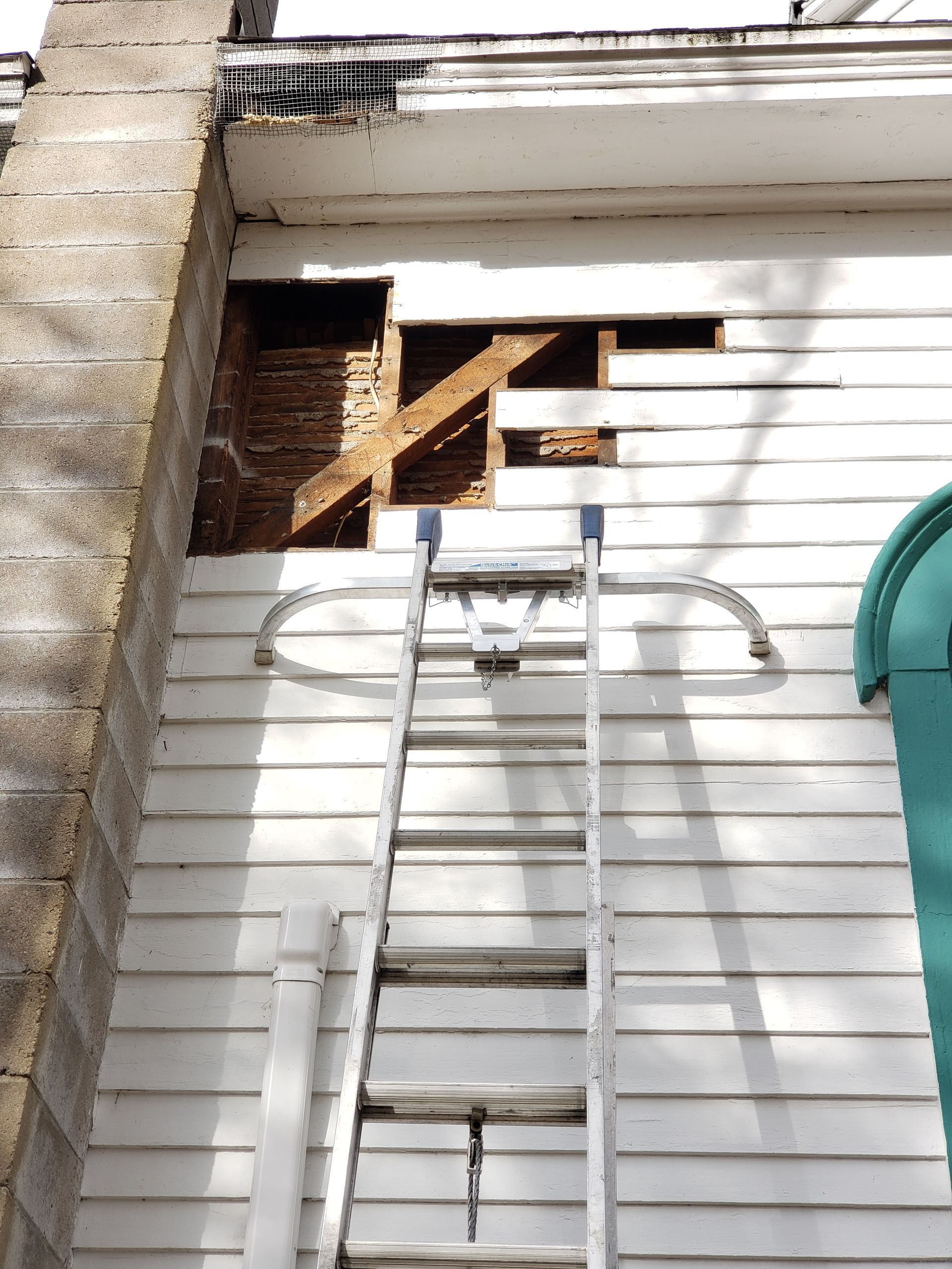 A ladder is attached to the side of a building.