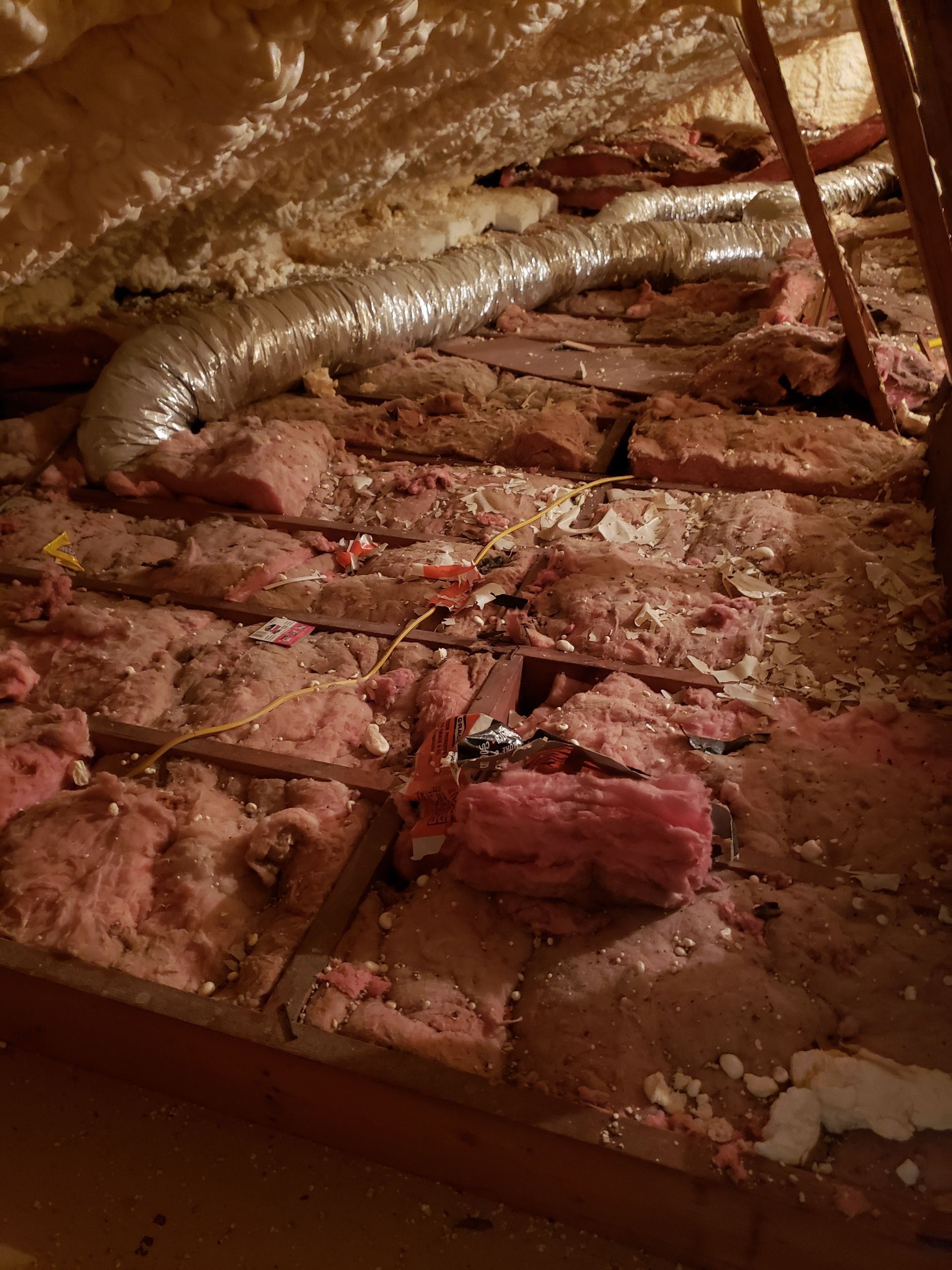 There is a lot of insulation in the attic of a house.