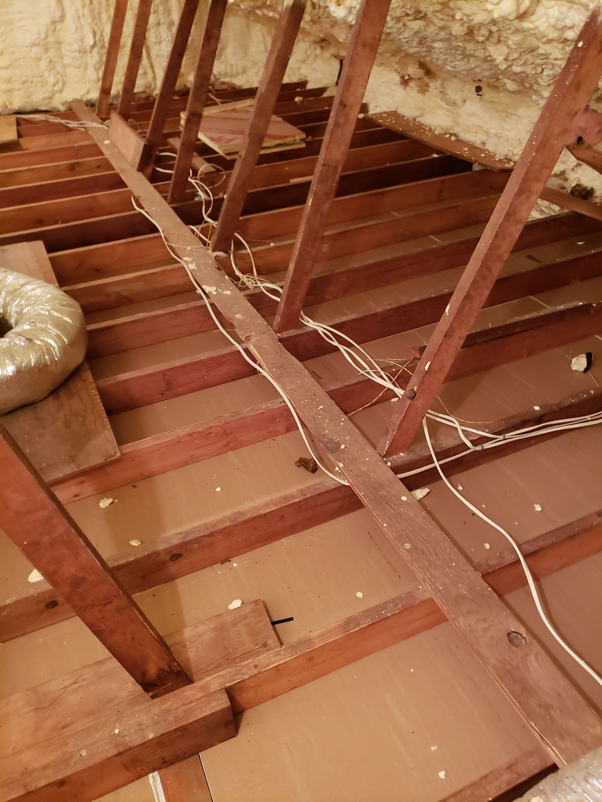 A wooden floor with a lot of wires coming out of it.