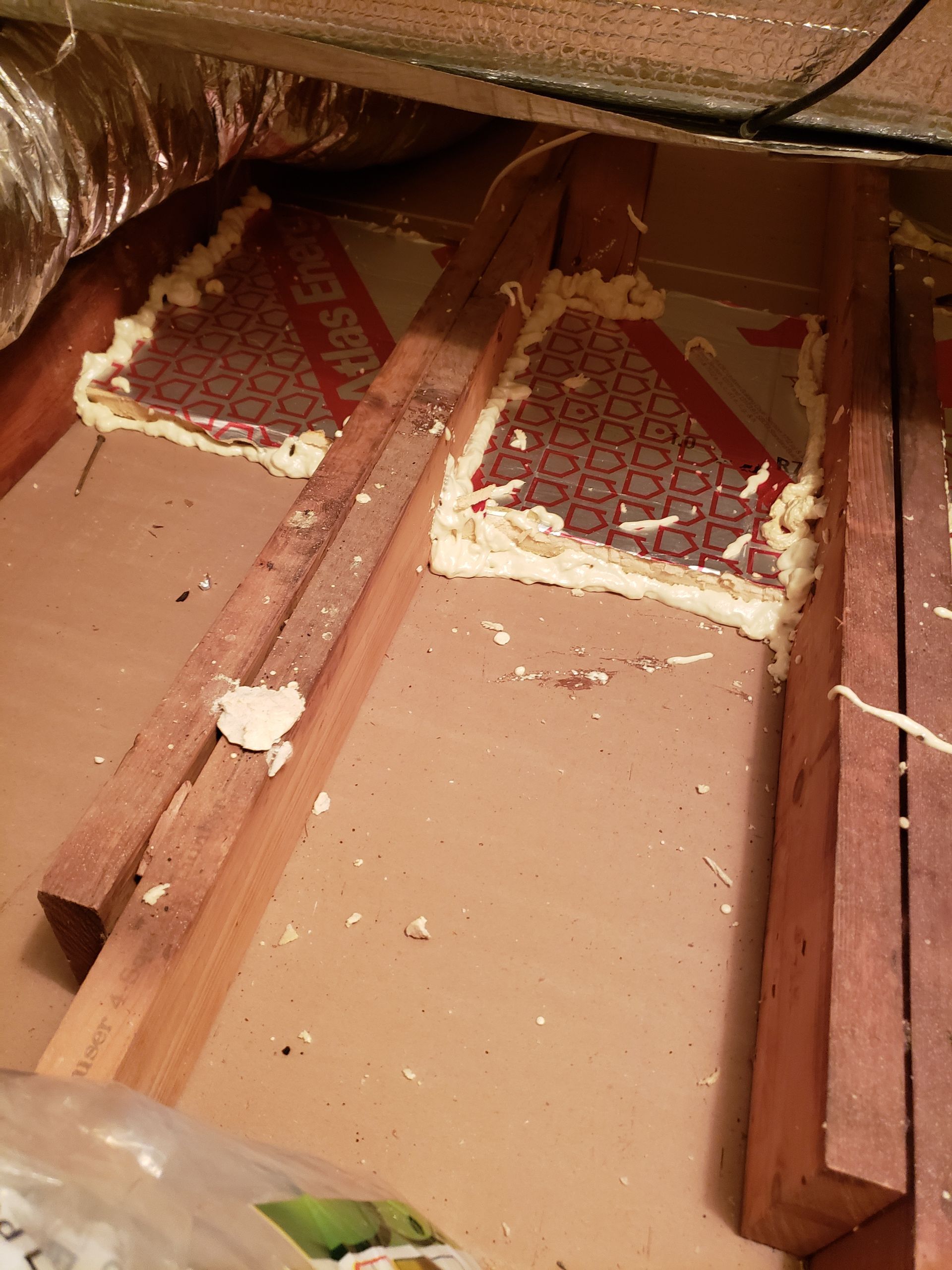 Pieces of styrofoam are laying on a wooden floor