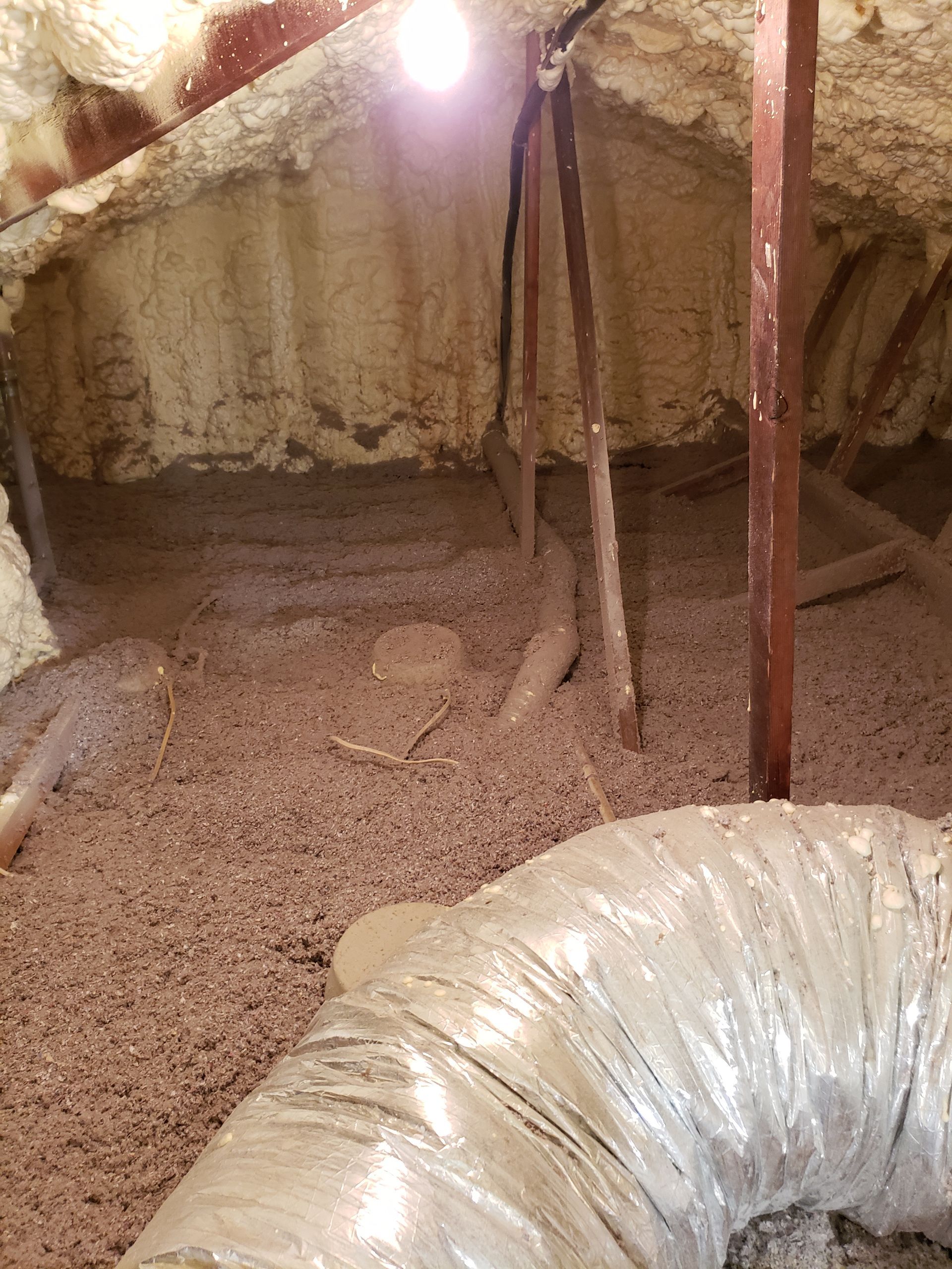 A room with a lot of insulation and a duct.