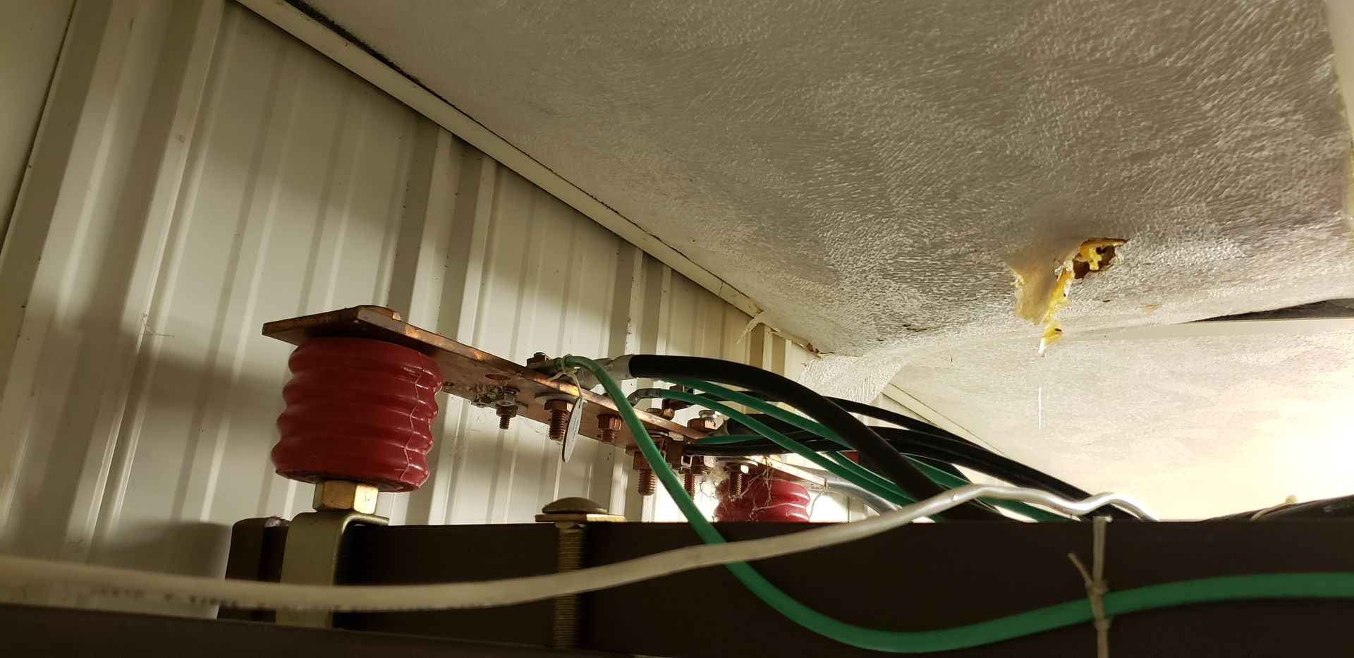 A bunch of wires are hanging from the ceiling of a building.