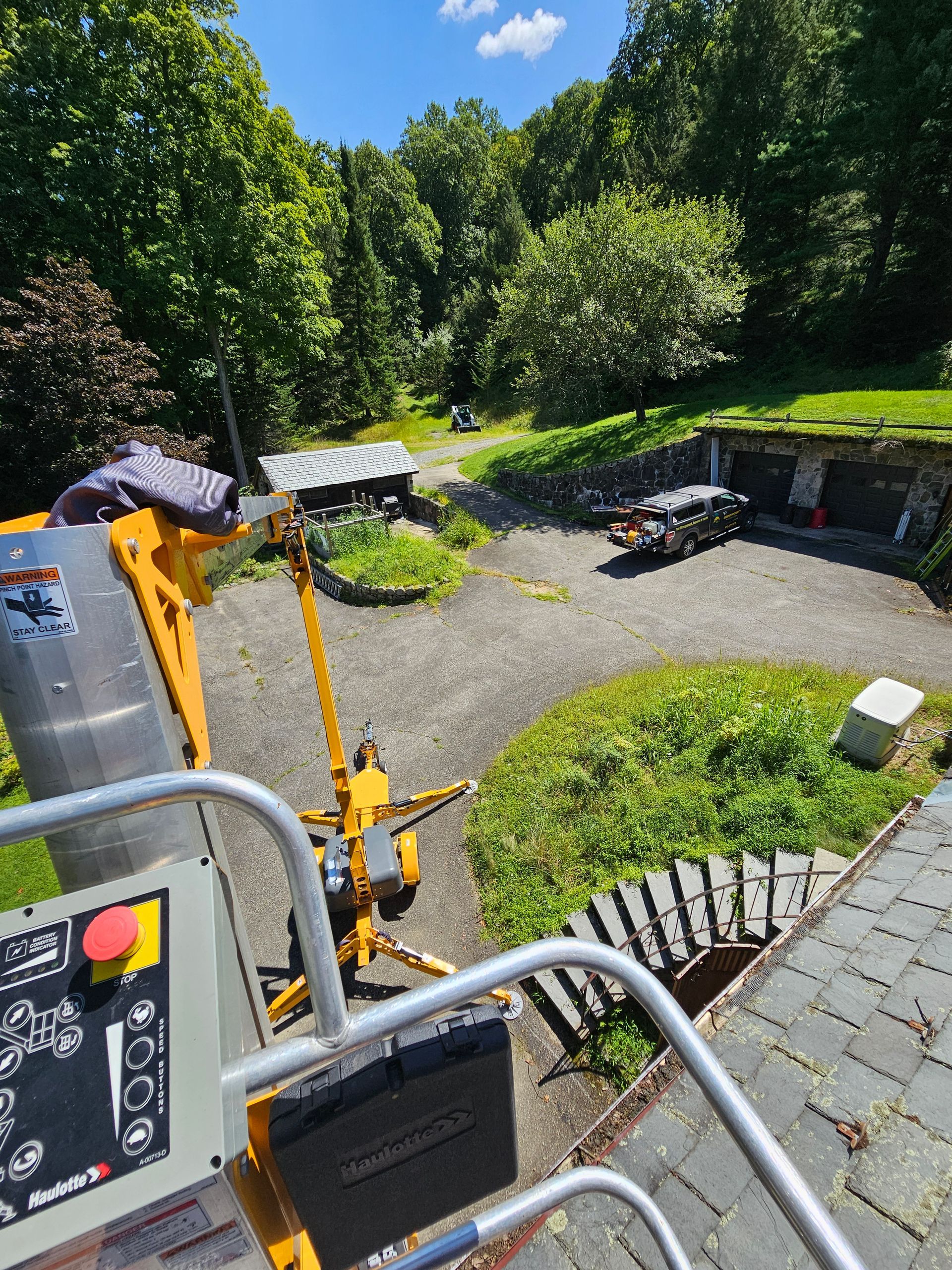 A yellow crane is sitting on top of a brick staircase.