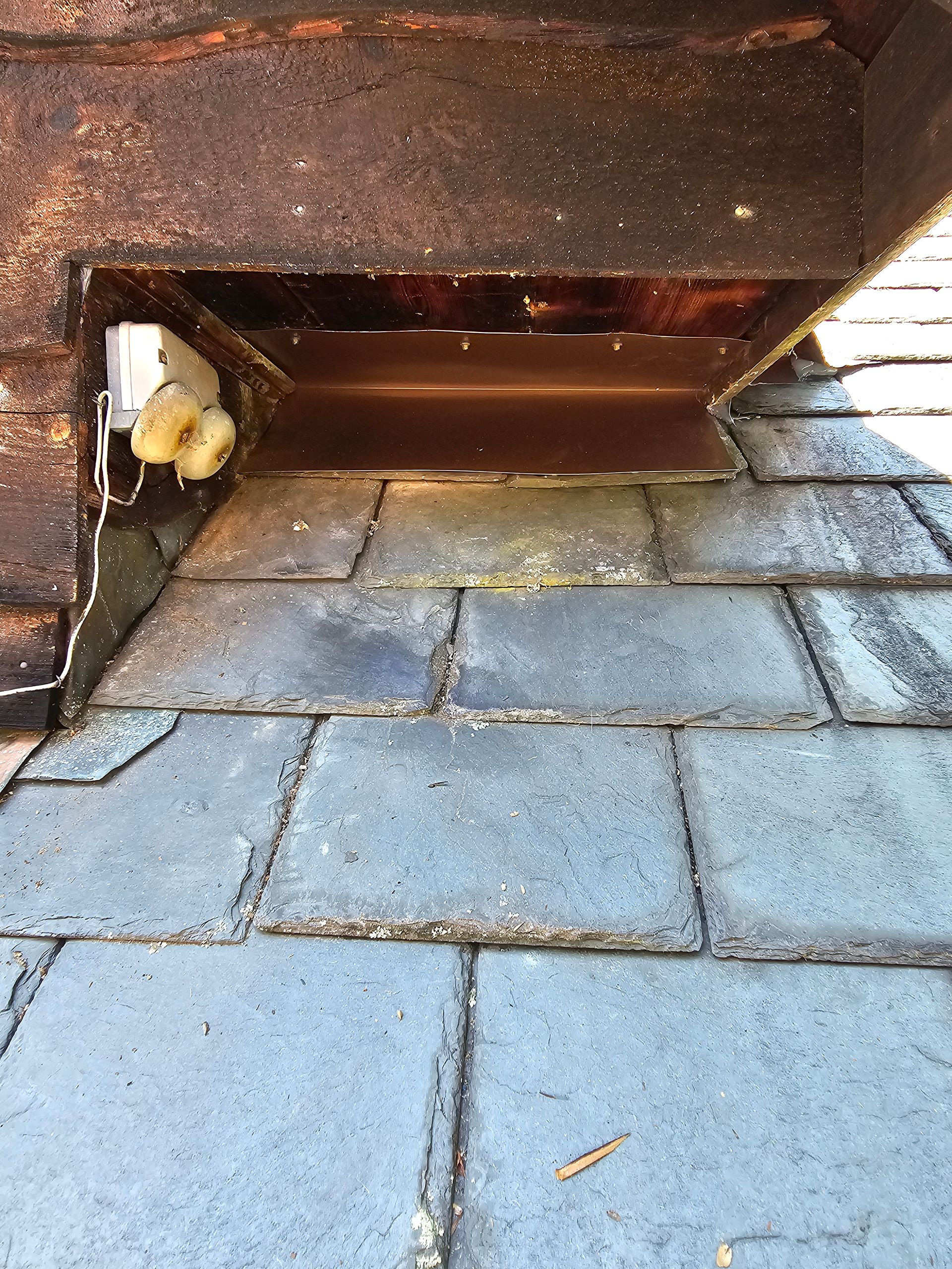 A close up of a roof with a hole in it.