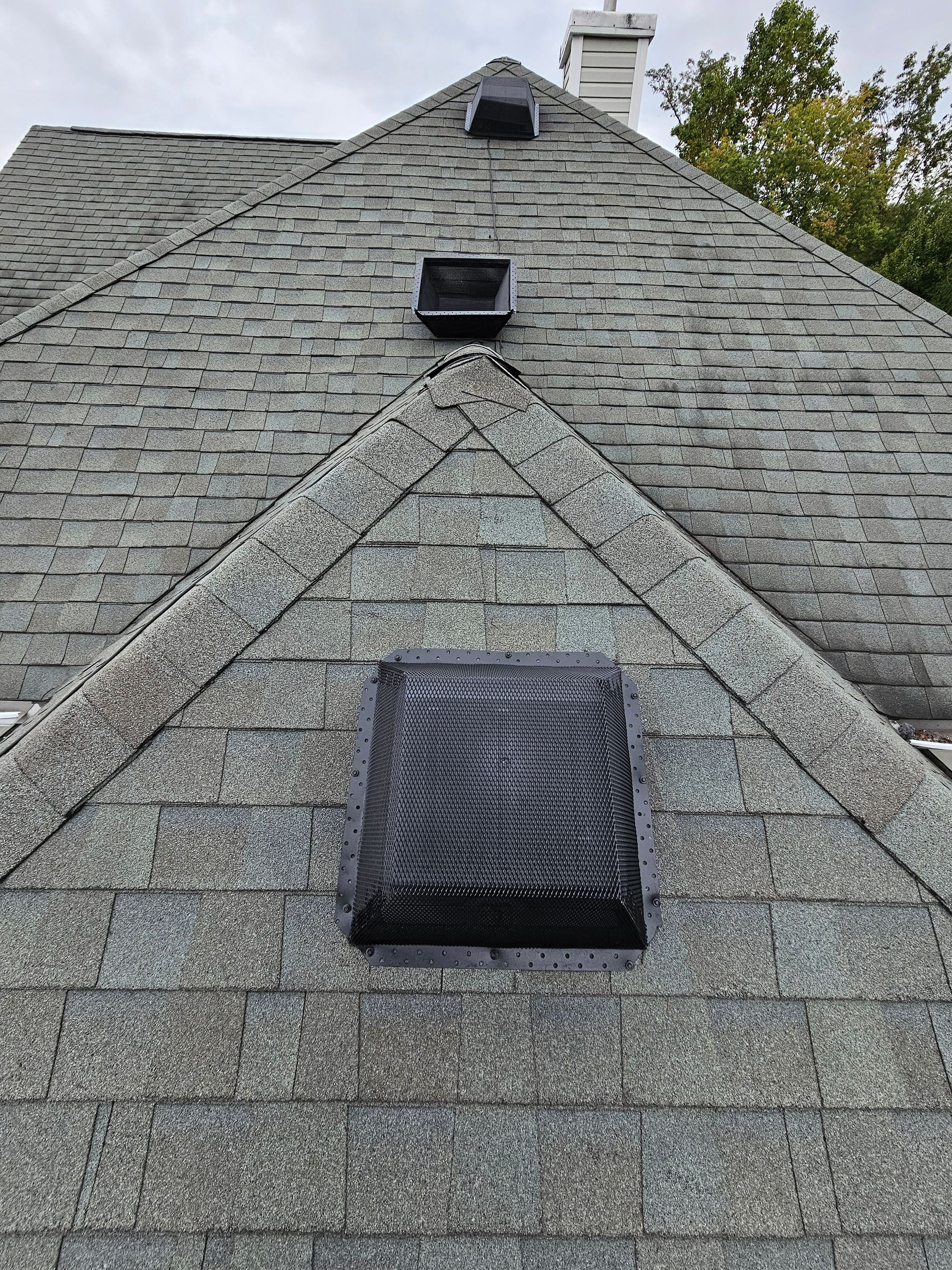 A close up of a roof with a skylight on it.