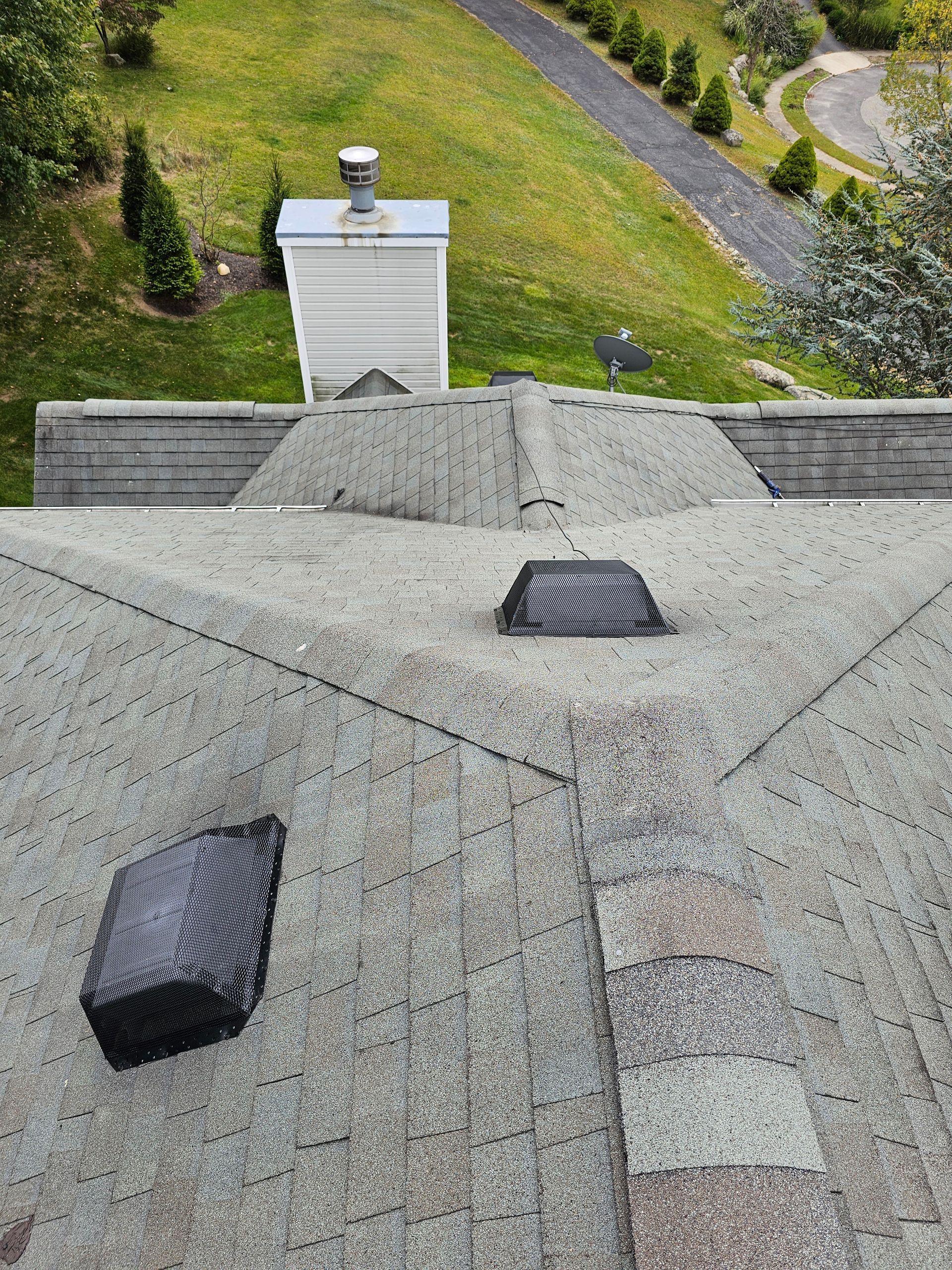 An aerial view of a roof with a chimney on it.