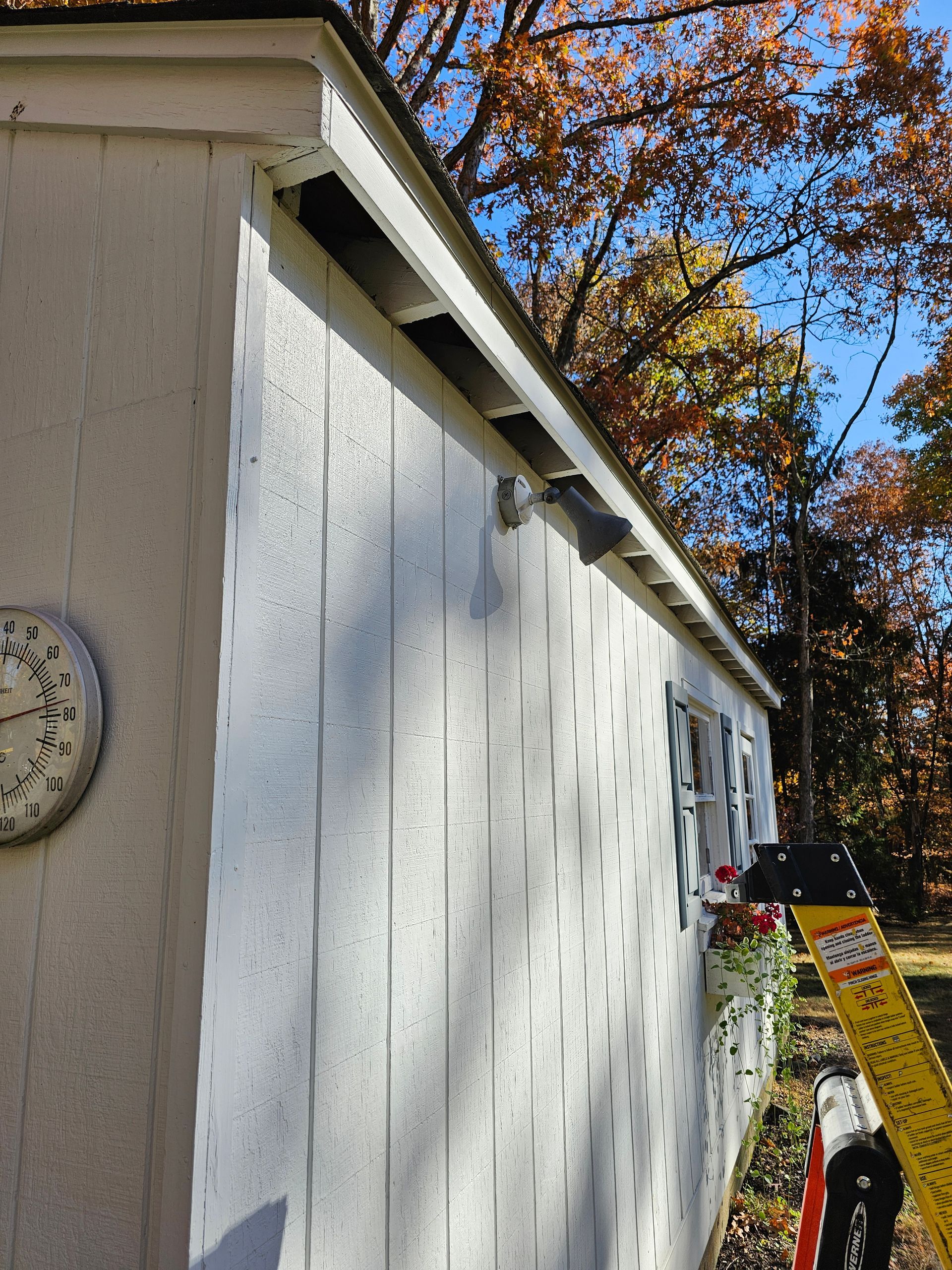 A clock on the side of a building shows the time as 4:20