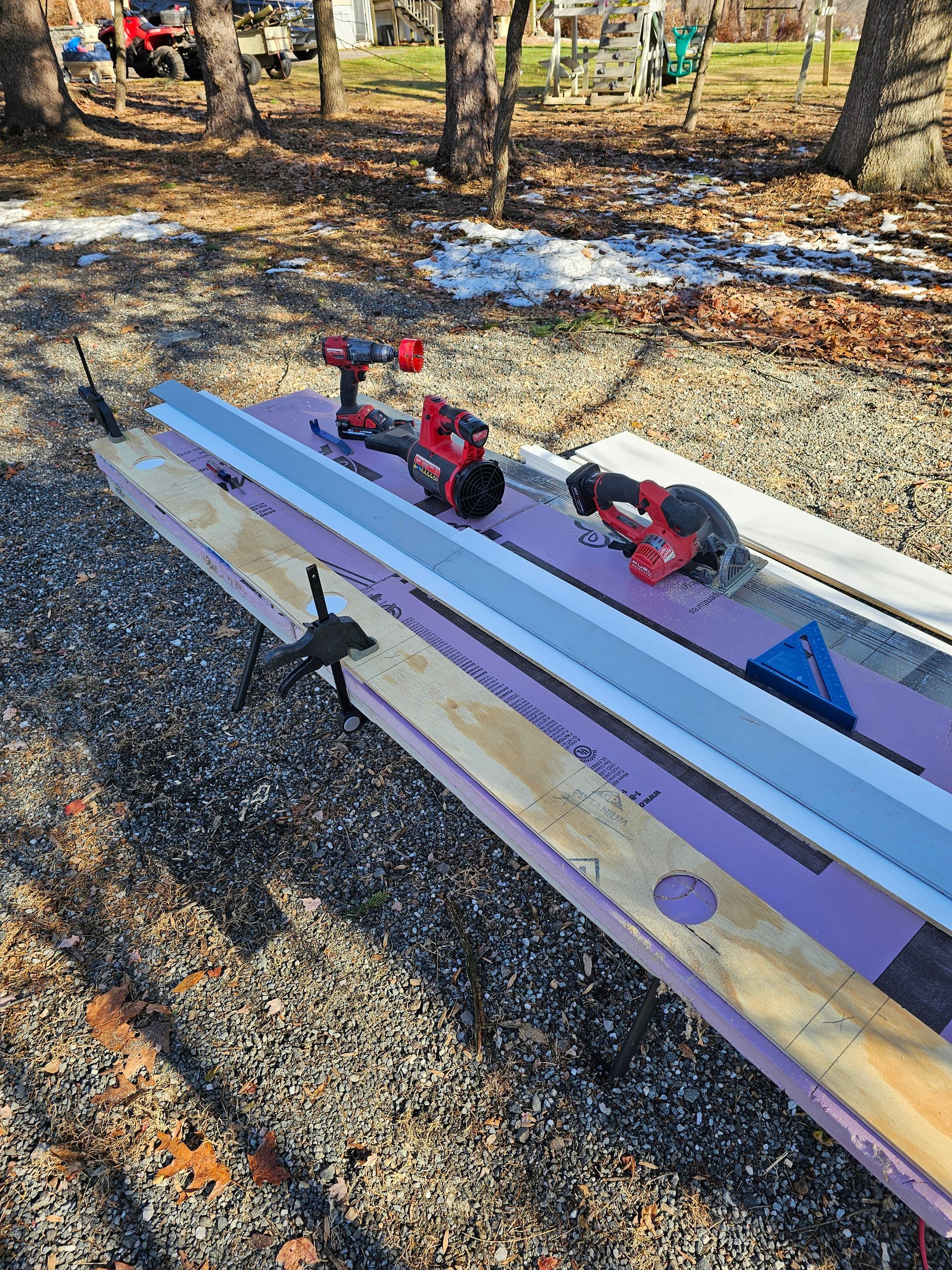 A bunch of tools are sitting on top of a wooden table.