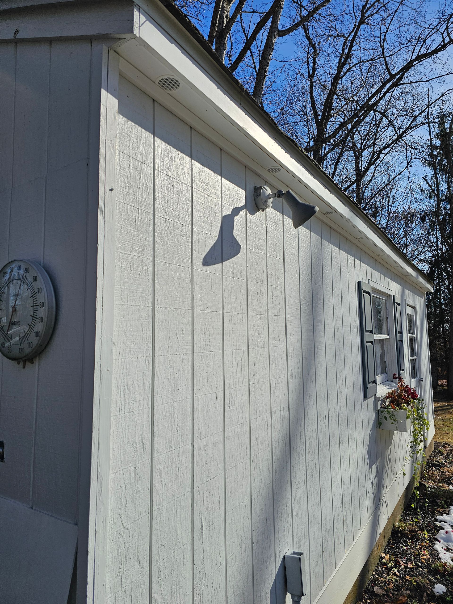 A white house with a clock on the side of it