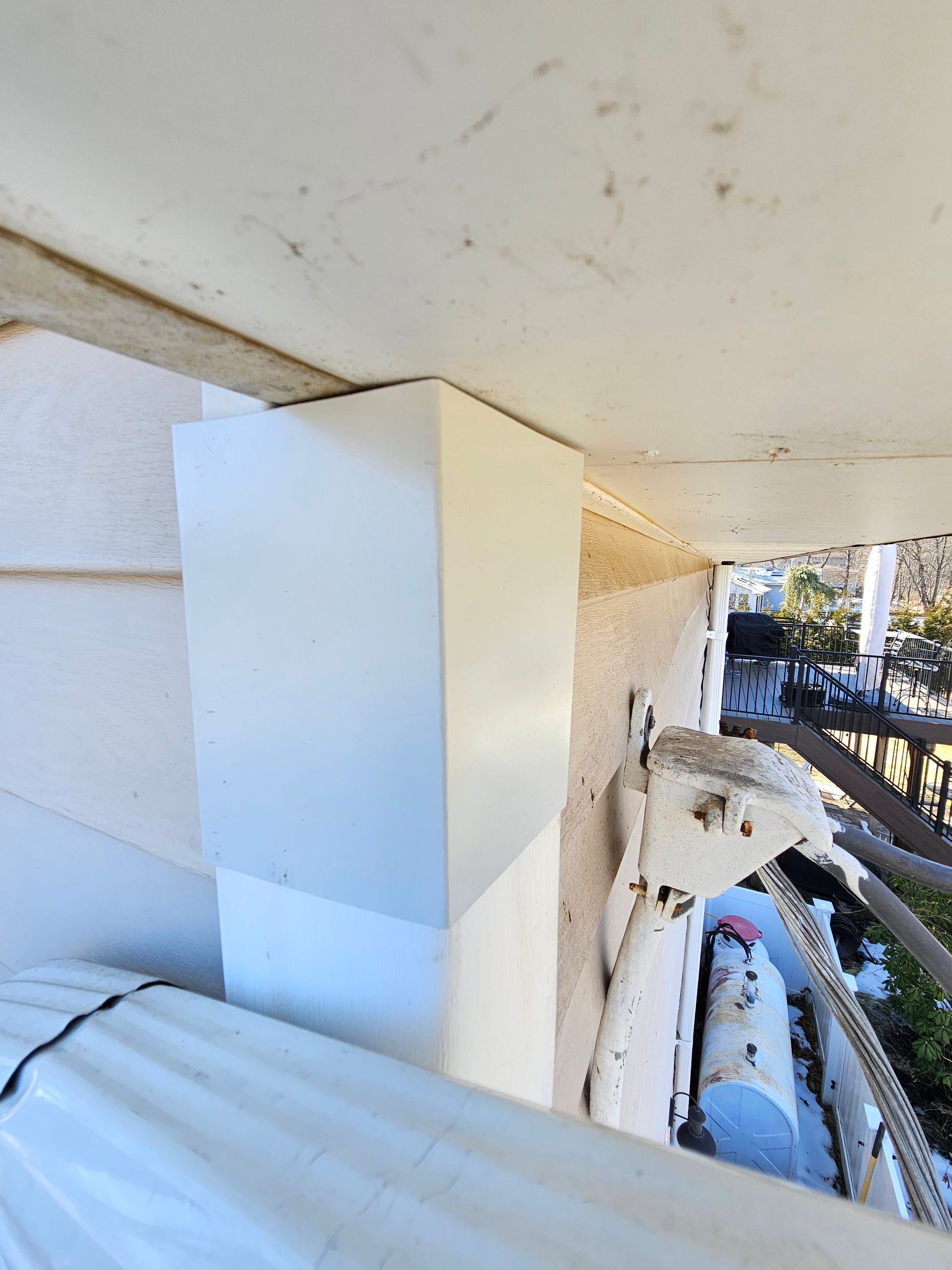 A white box is sitting on the side of a building.