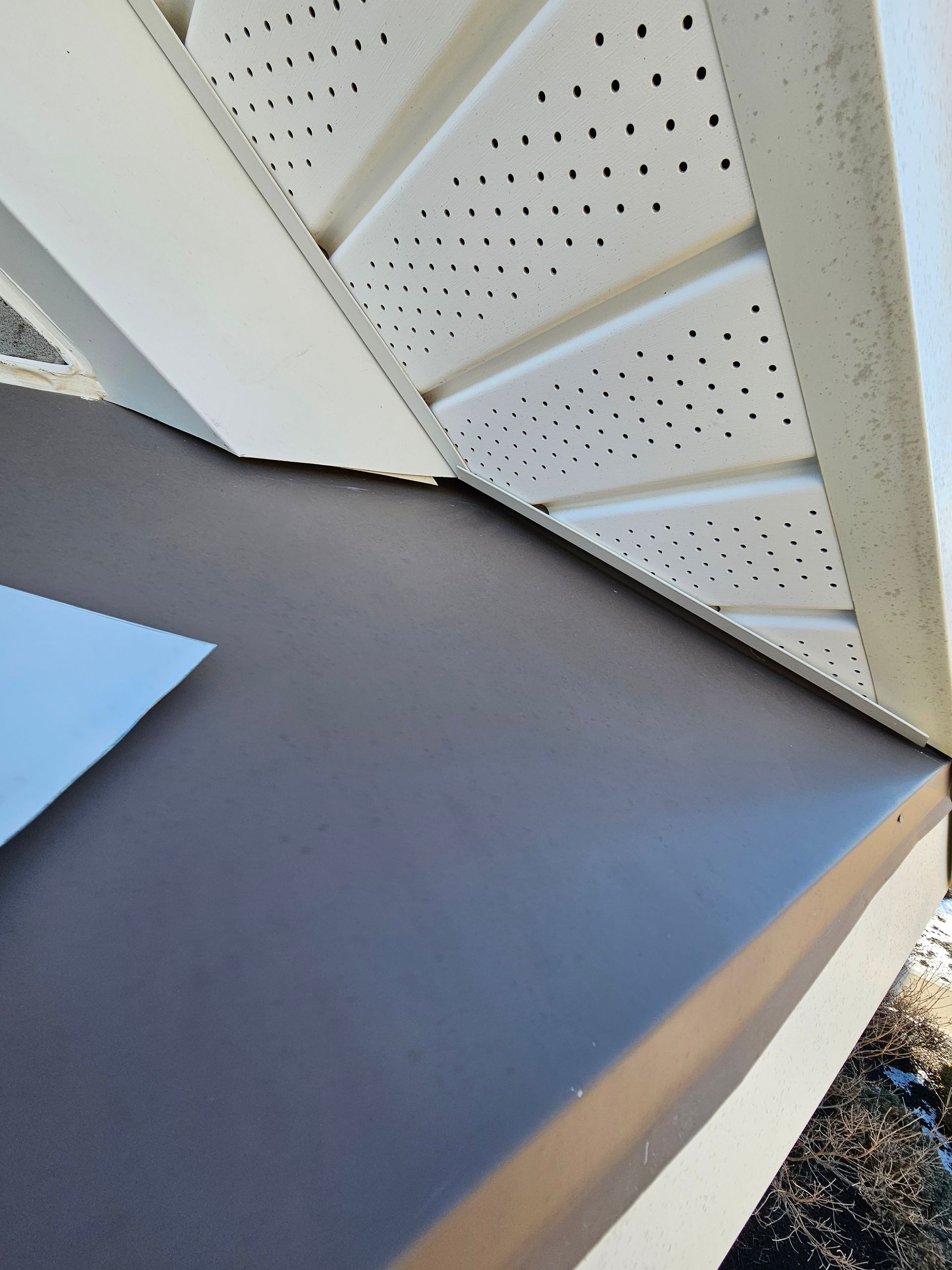 A close up of a porch with a roof and a ceiling.