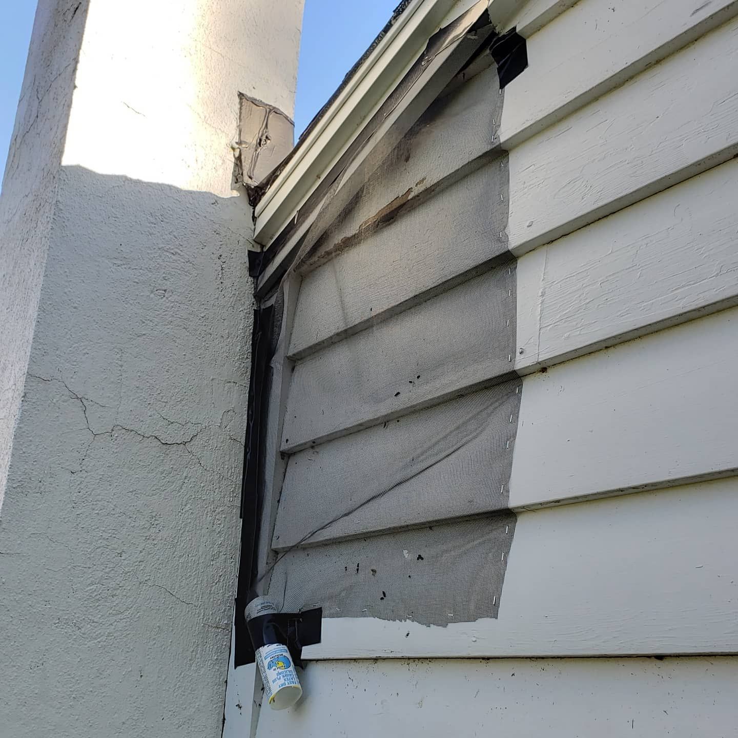 A white house with a chimney on the side